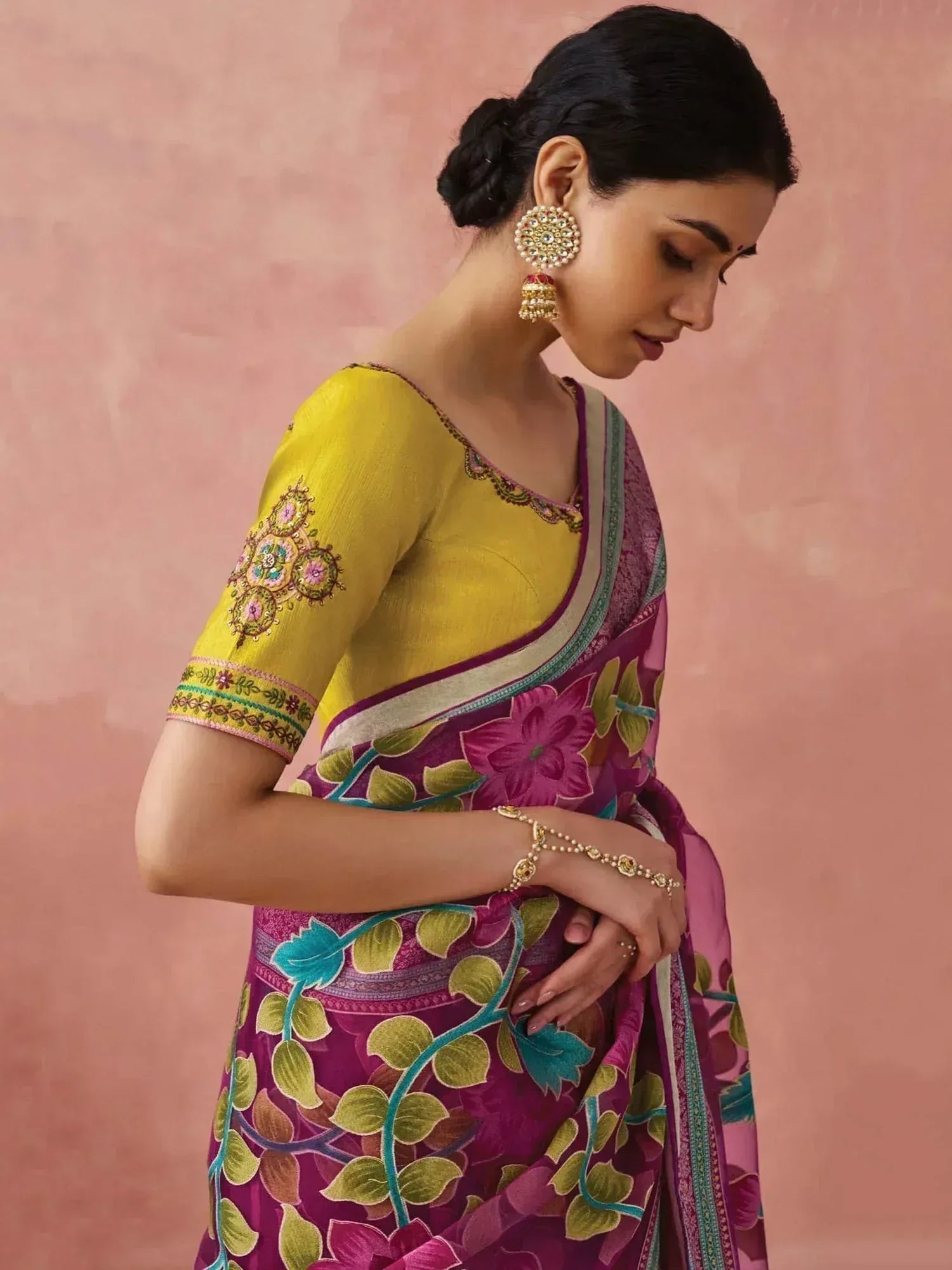 Woman in vibrant purple floral saree with yellow embroidered blouse, traditional Indian ethnic wear