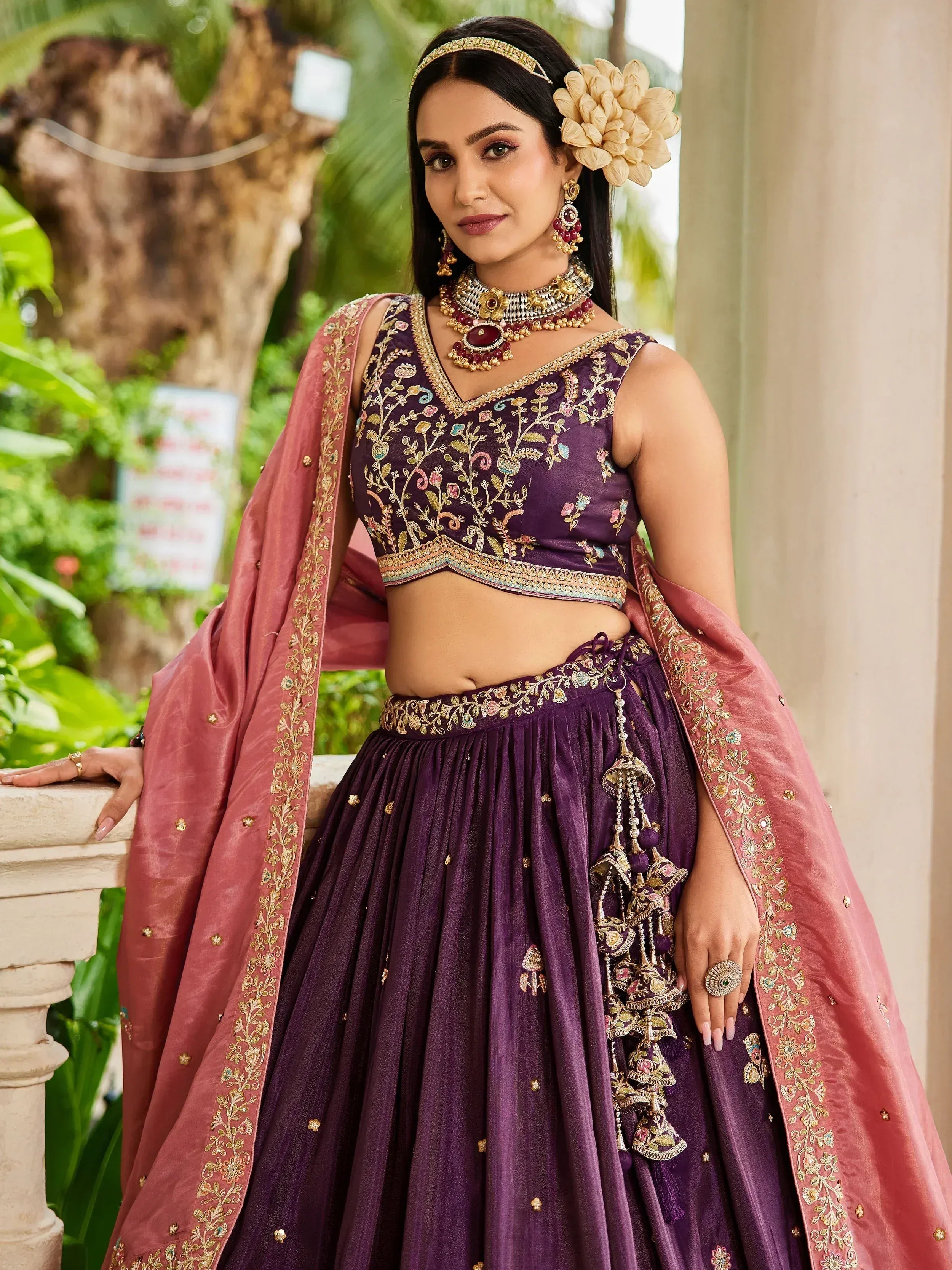 Purple embroidered lehenga choli with pink dupatta, perfect for Indian weddings and festive occasions.