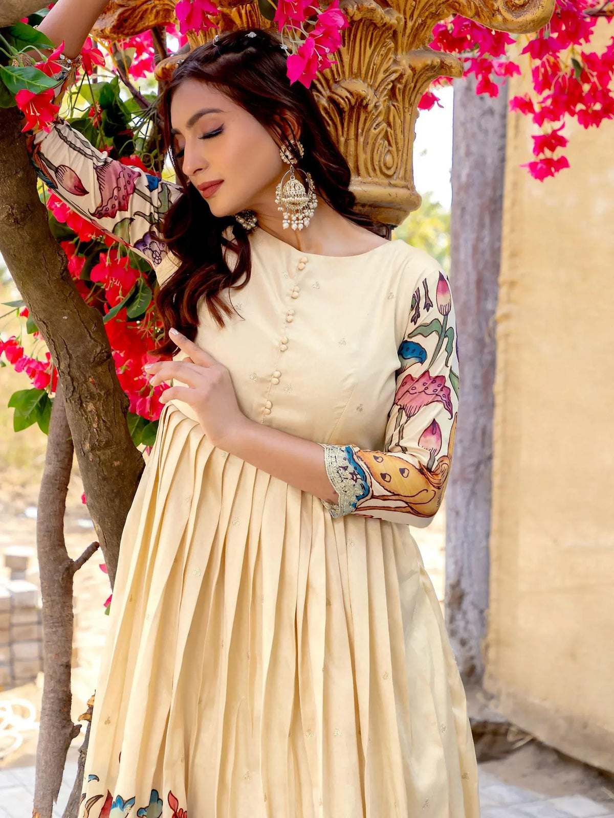 Cream floral print ethnic gown with pleated skirt, perfect for Indian occasions and festive wear.