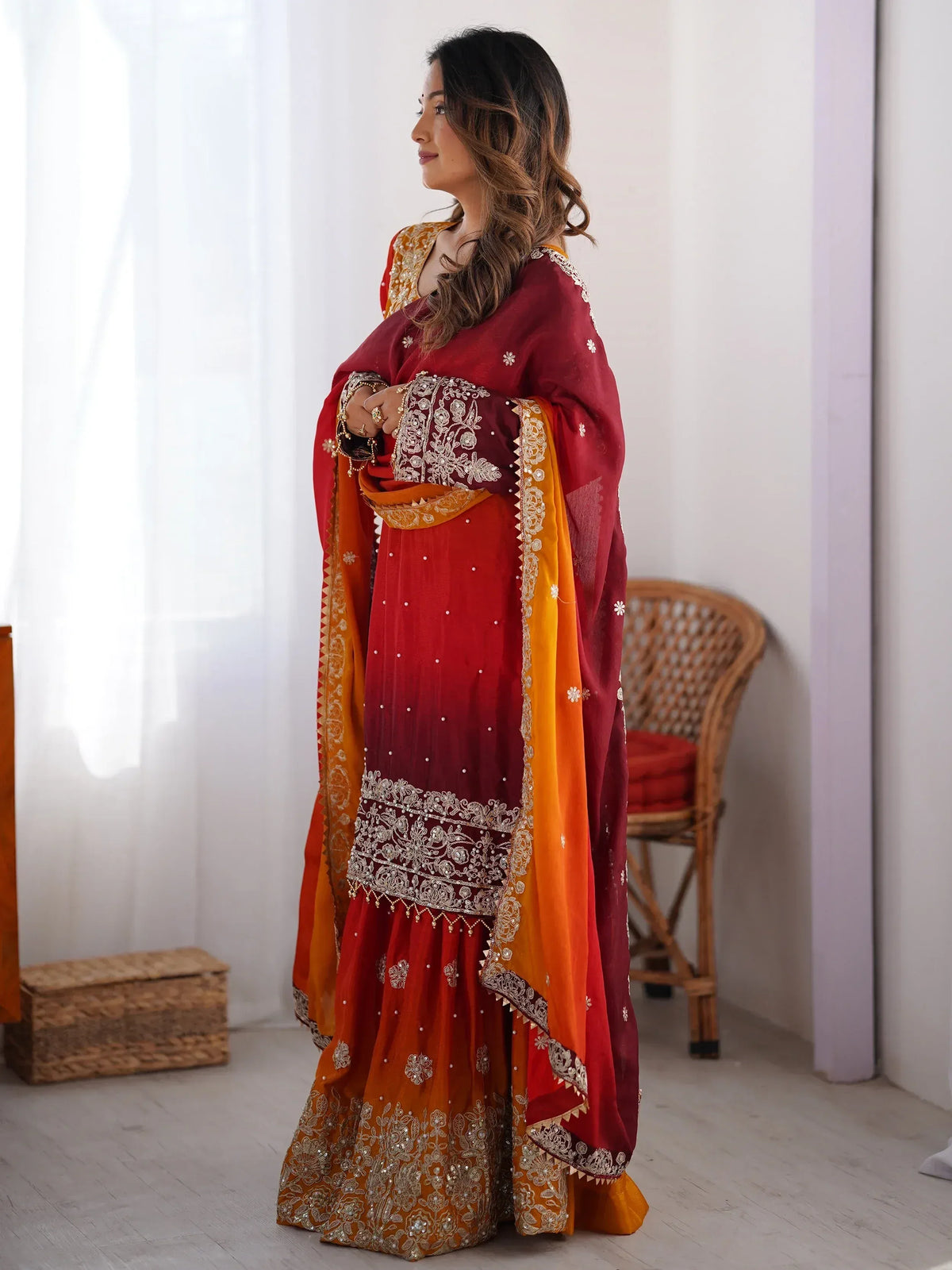 Red and orange embroidered lehenga choli with gold detailing, perfect for Indian ethnic wear occasions.