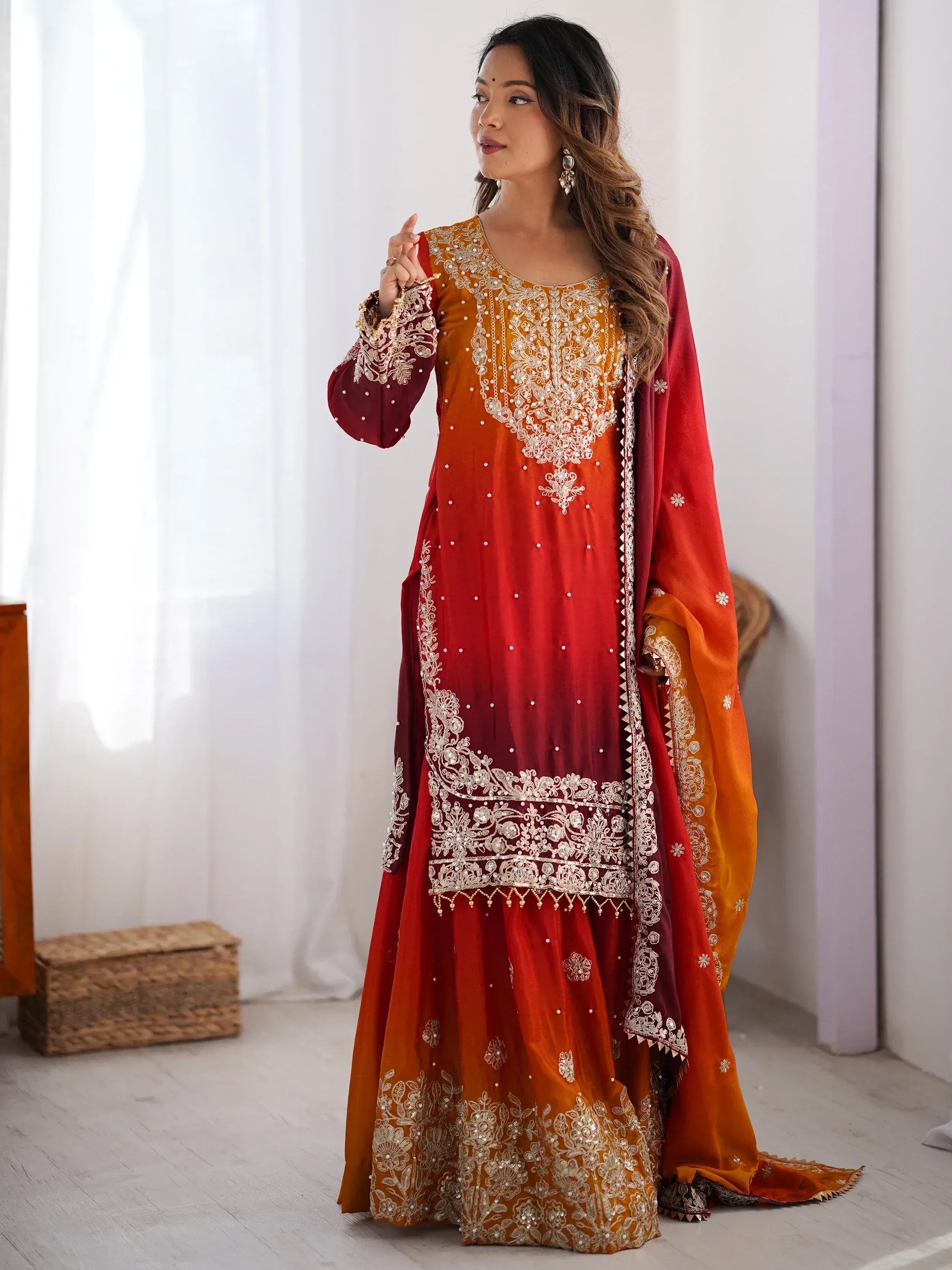 Woman in elegant red and gold embroidered salwar kameez with matching dupatta, Indian ethnic wear