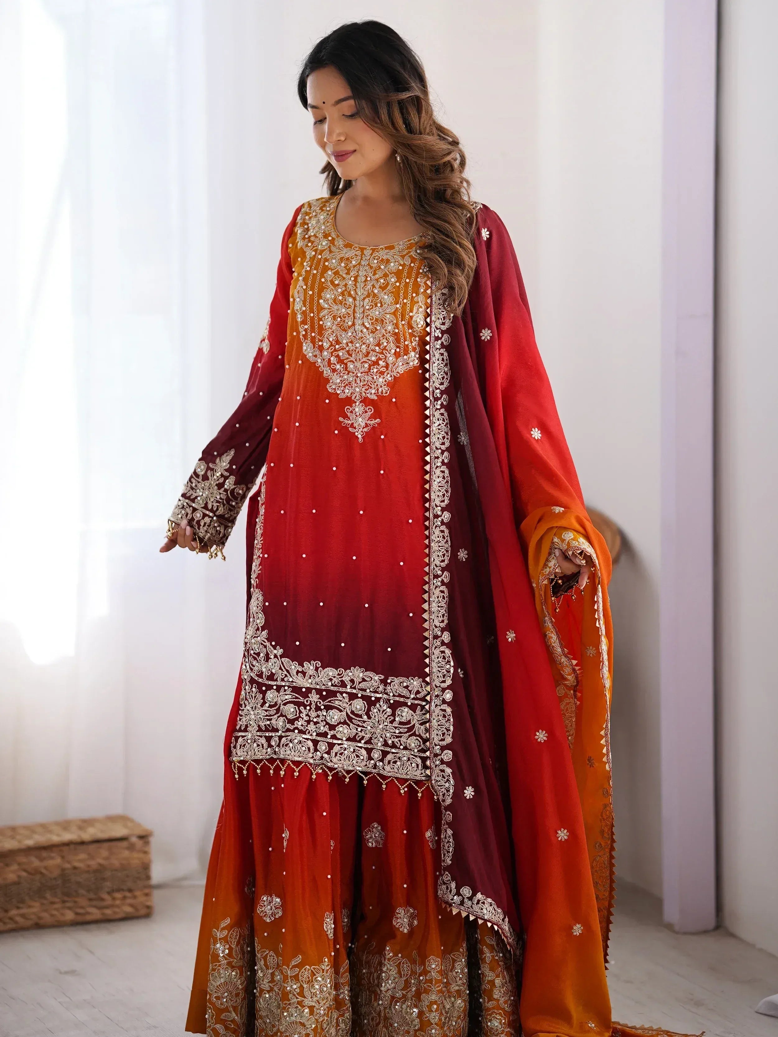 Elegant red and orange embroidered salwar kameez with gold detailing, perfect for Indian ethnic wear occasions.