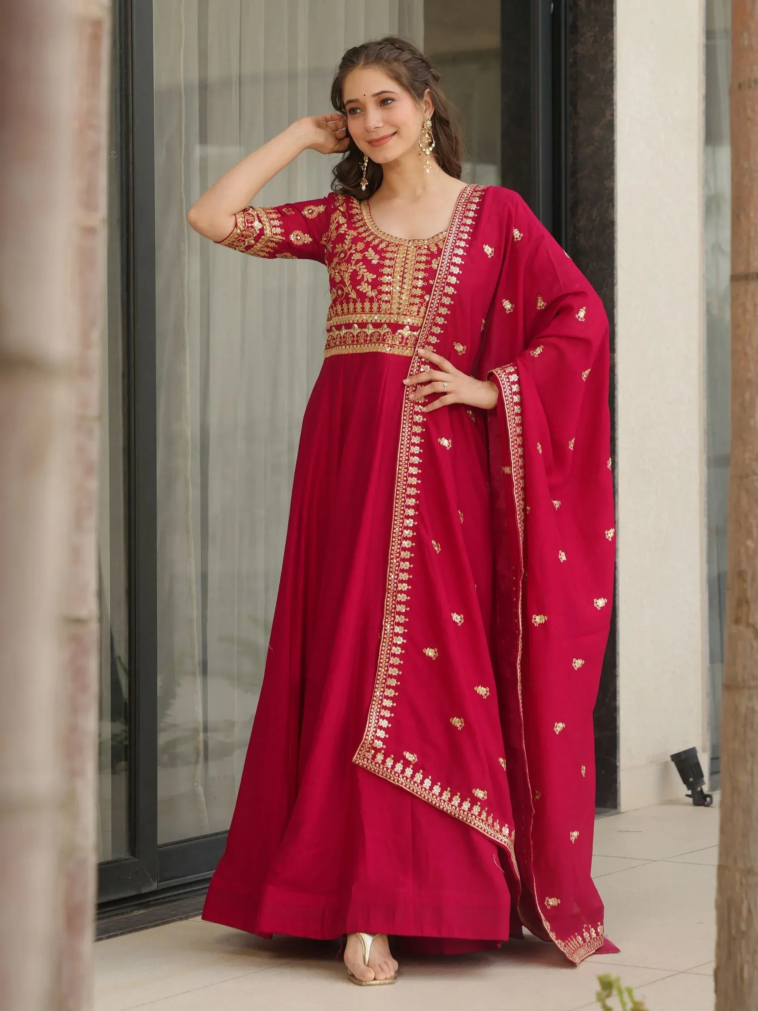 Red ethnic anarkali suit with gold embroidery, perfect for Indian occasions and festive wear