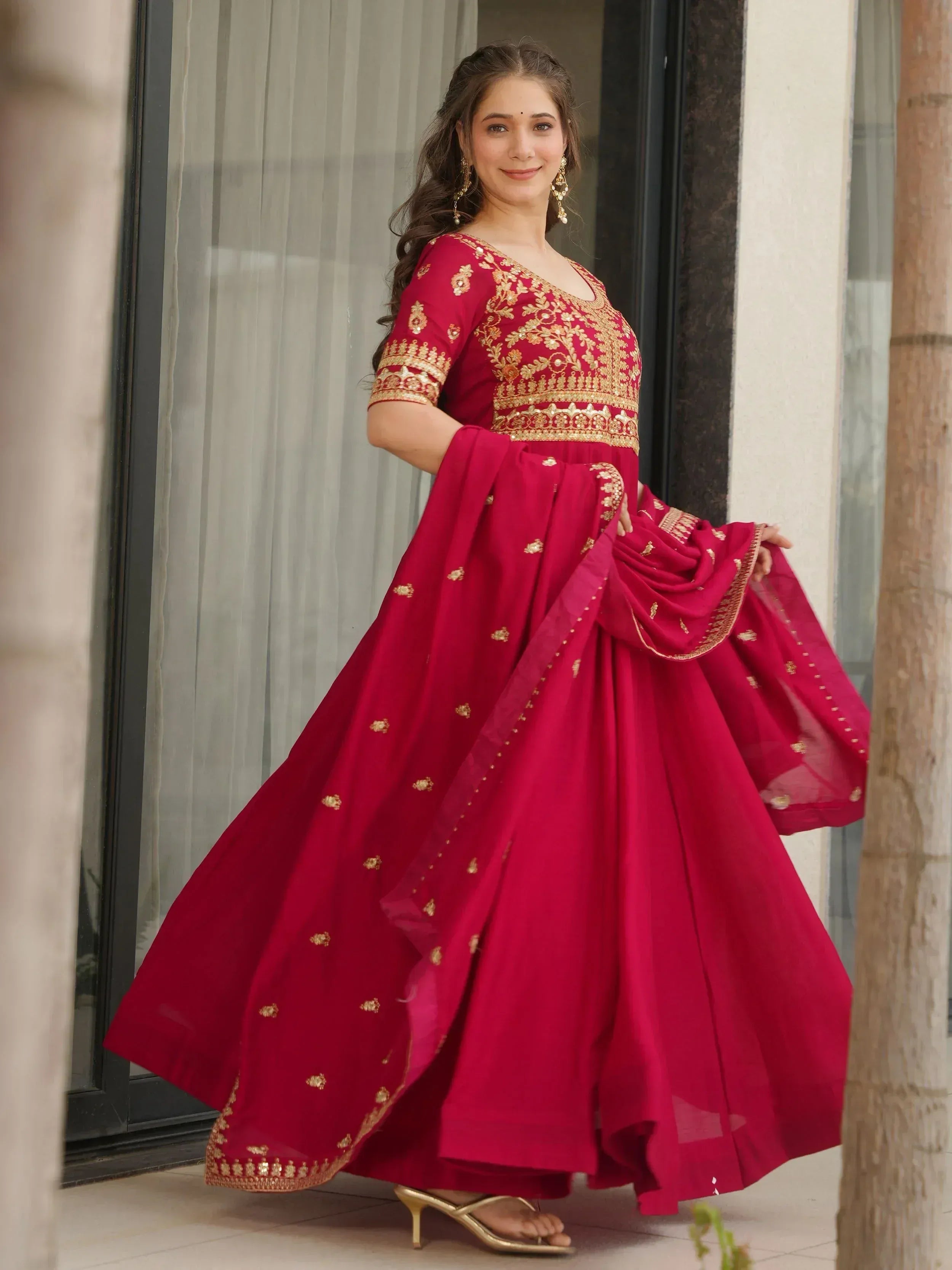 Woman in maroon ethnic anarkali with gold embroidery, perfect for Indian festive occasions
