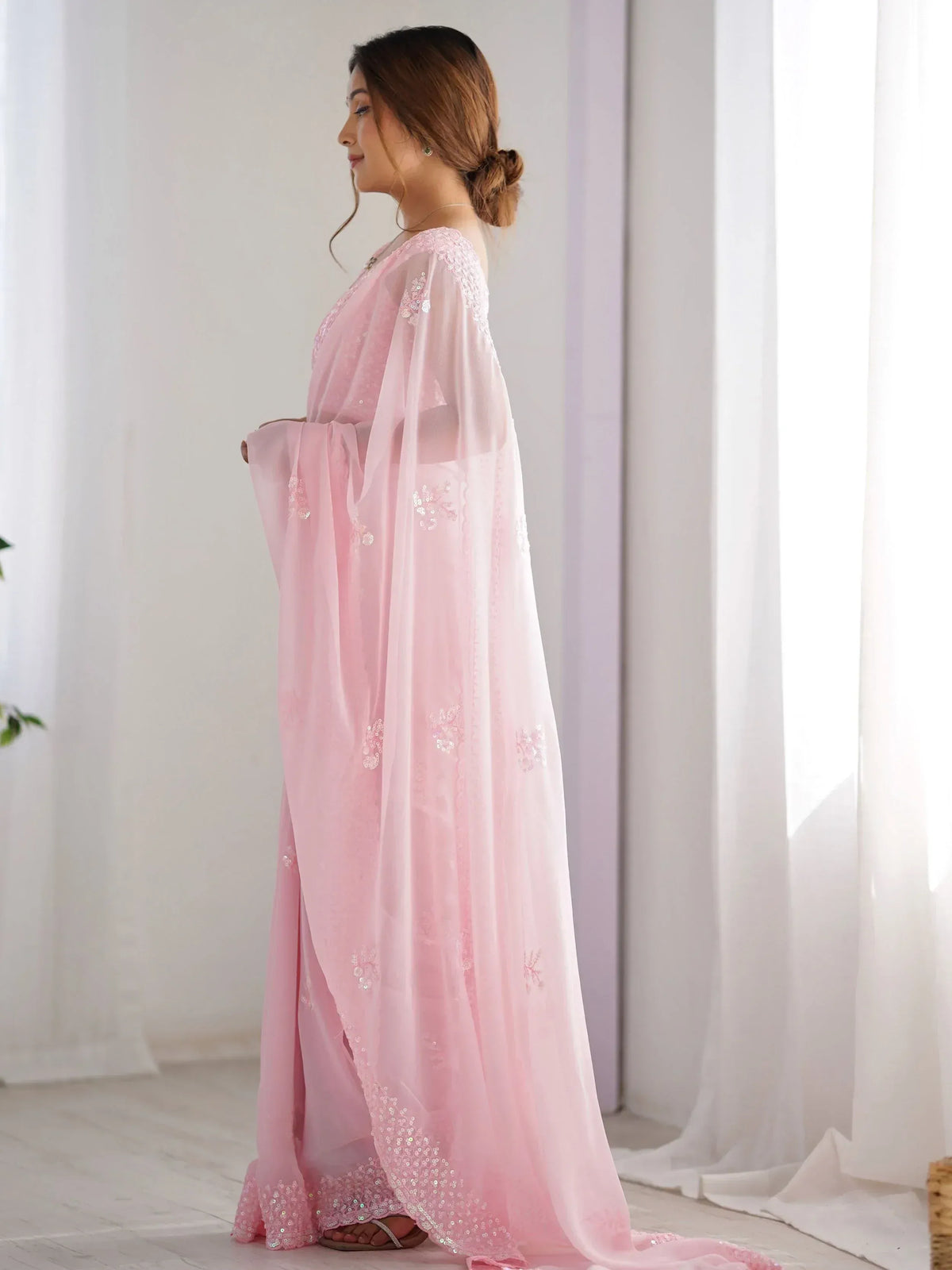 Pink ethnic gown with sequin embroidery, sheer cape, and flared sleeves for Indian wear