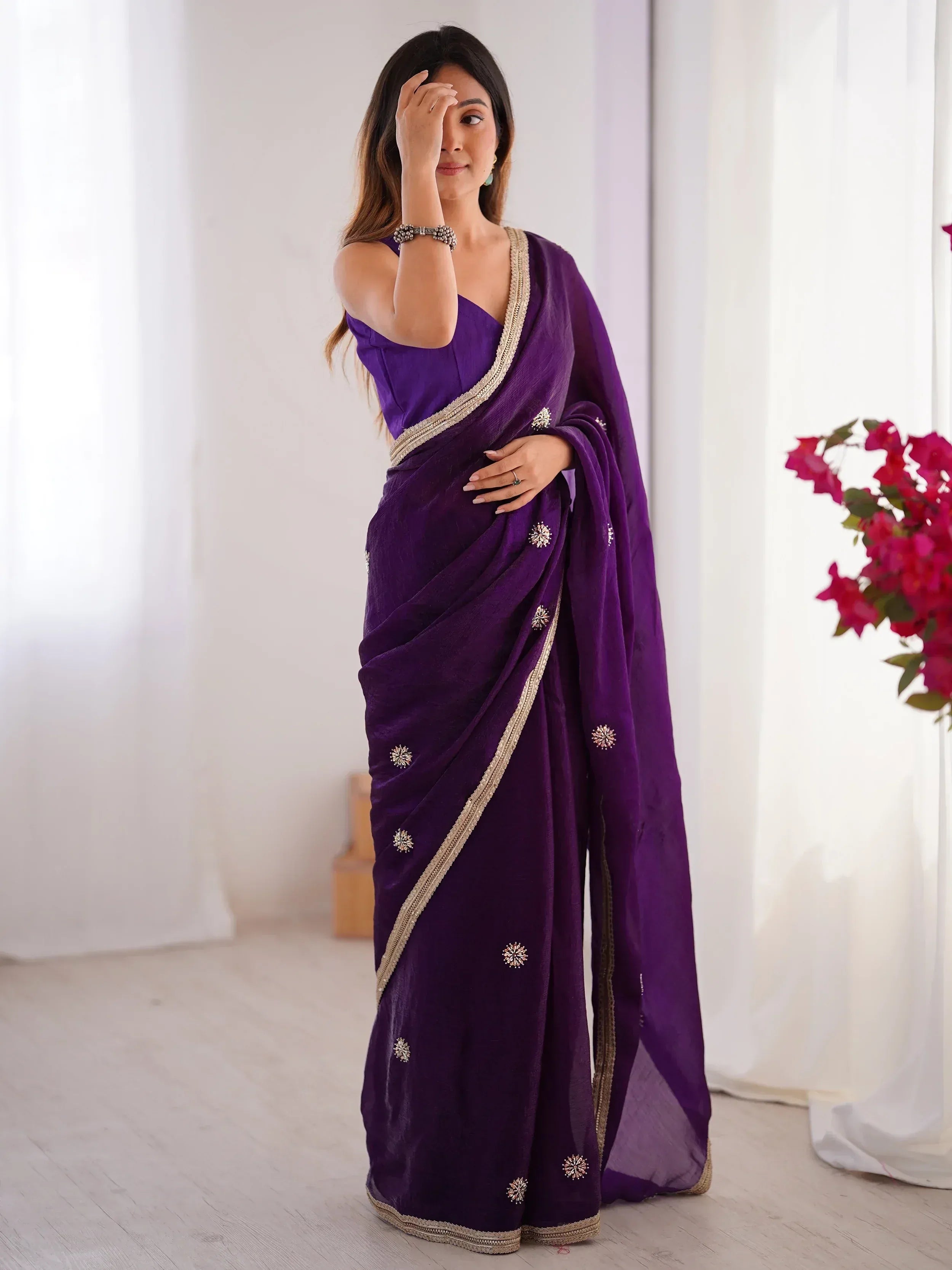 Purple designer saree with gold embroidery and embellishments, perfect for Indian ethnic wear occasions
