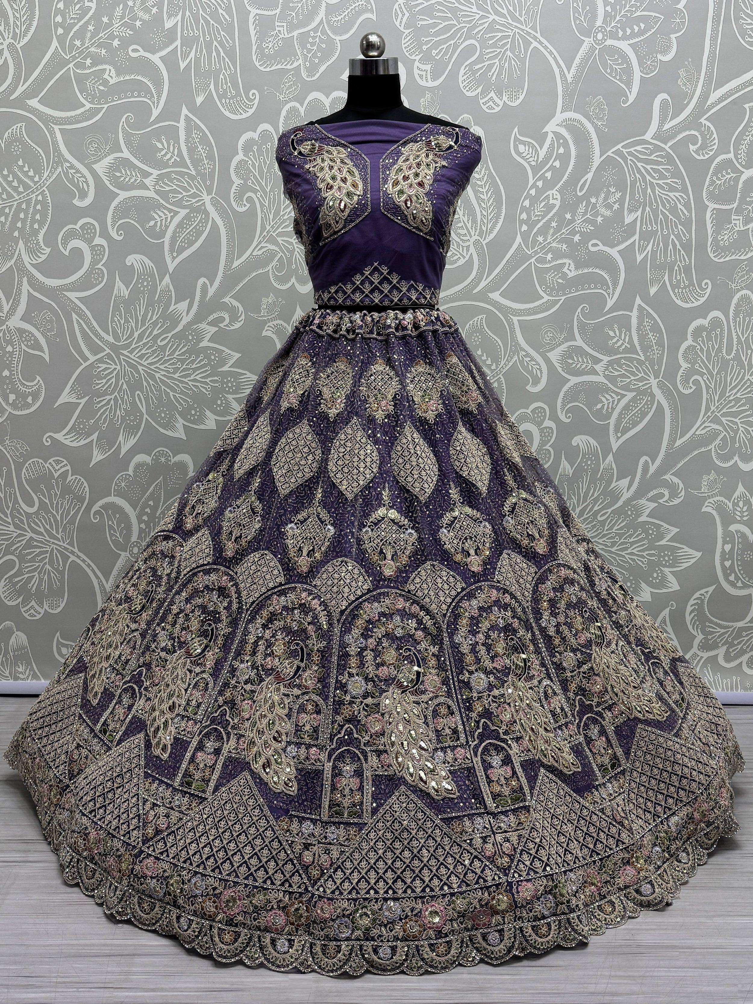 Purple designer lehenga choli with heavy gold embroidery and peacock motifs, perfect for Indian weddings and festivals.