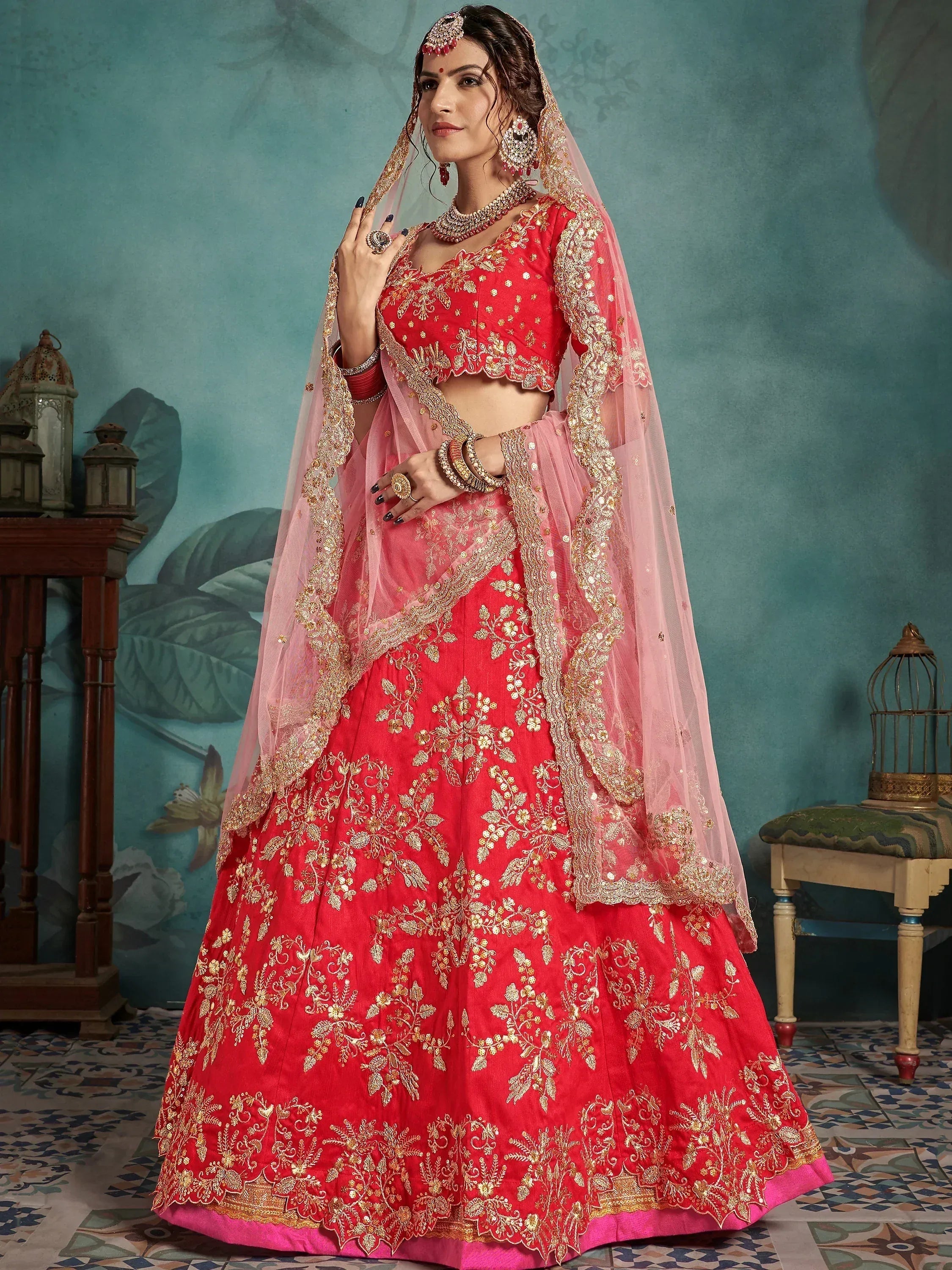 Red and pink embroidered lehenga choli with gold floral work, perfect for Indian weddings and festive occasions.