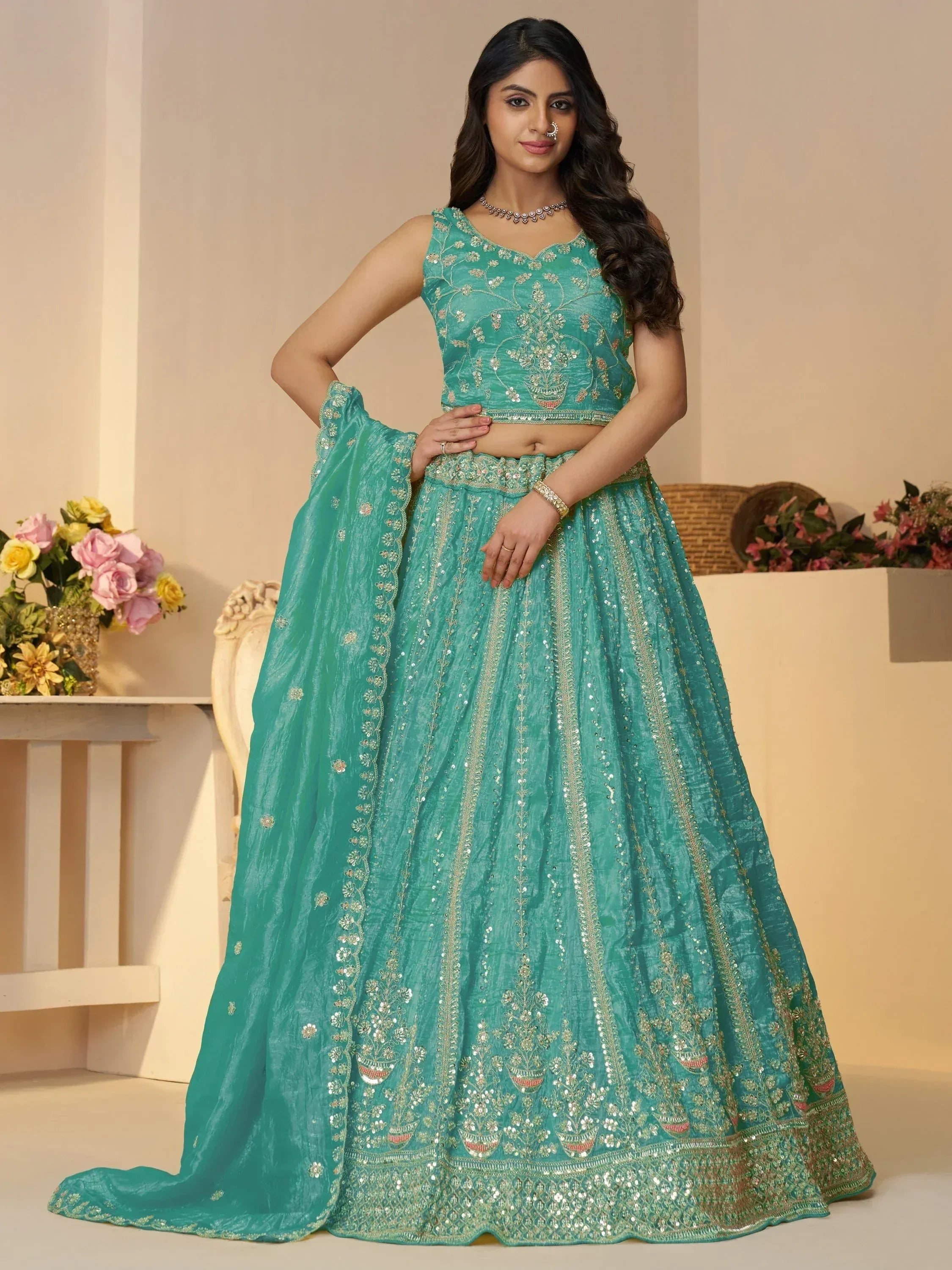 Teal designer lehenga choli with intricate gold embroidery and sequin work, perfect for Indian ethnic occasions