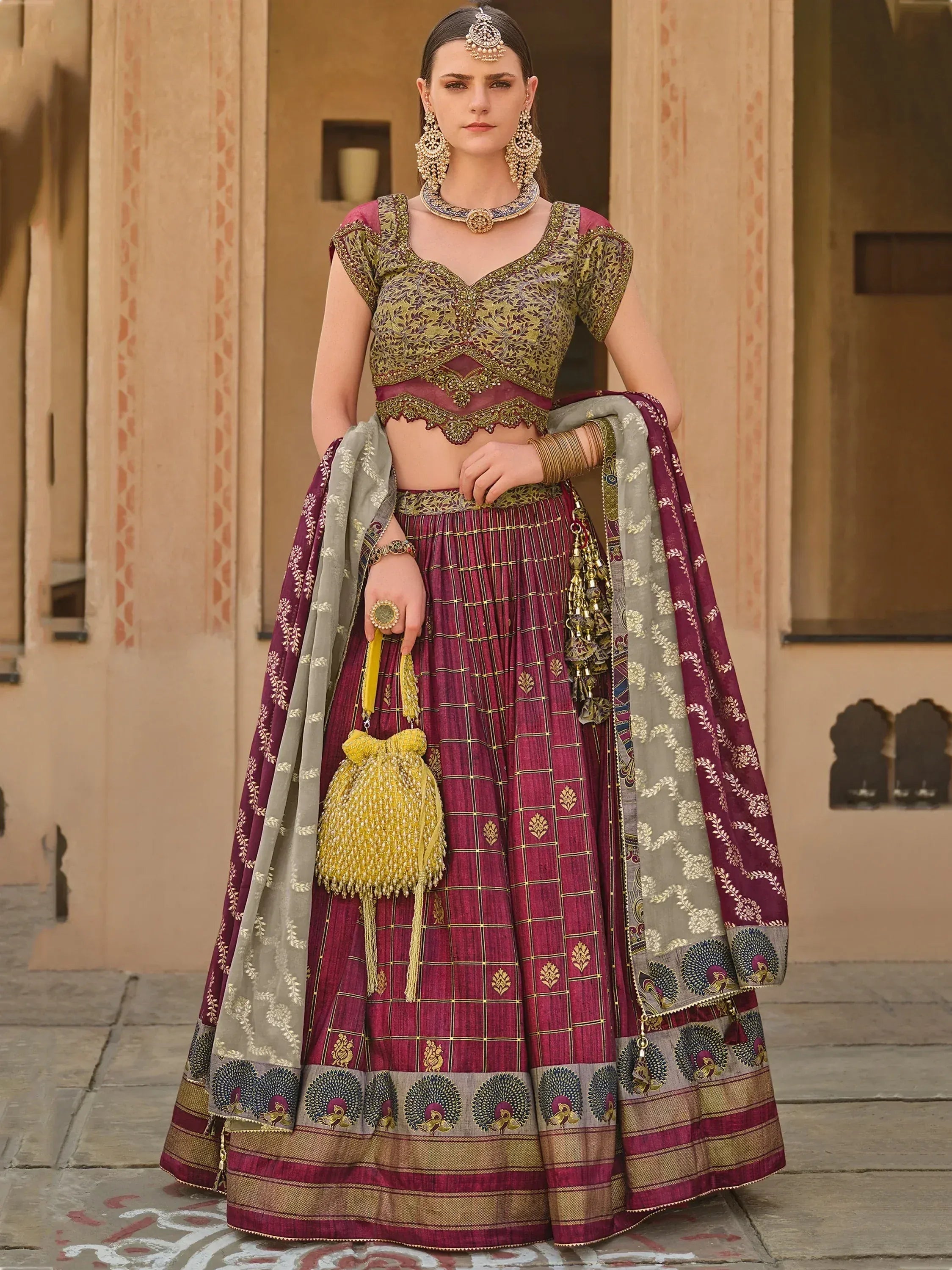 Elegant maroon and gold lehenga choli with peacock motifs, perfect for Indian weddings and festive occasions.
