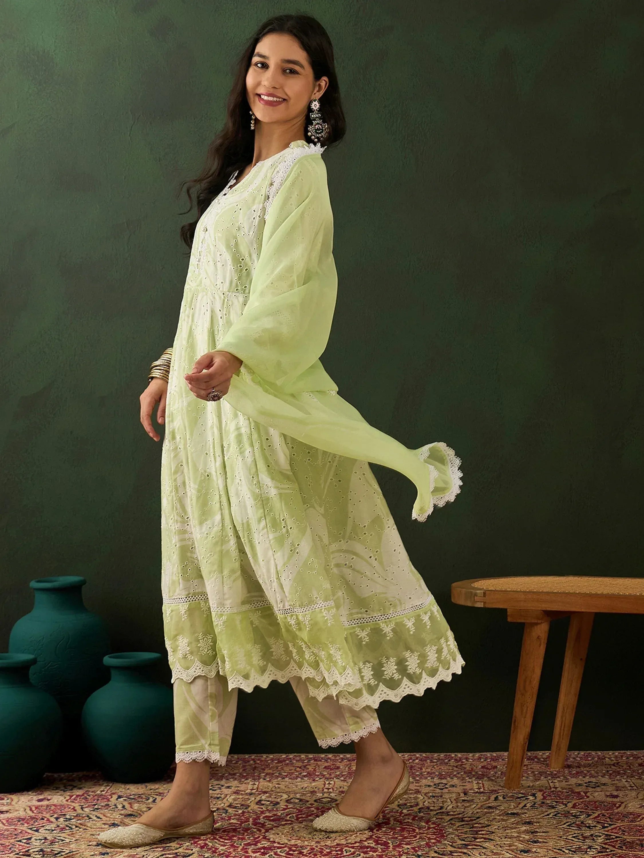 Woman in pastel green embroidered salwar kameez with dupatta, traditional ethnic wear