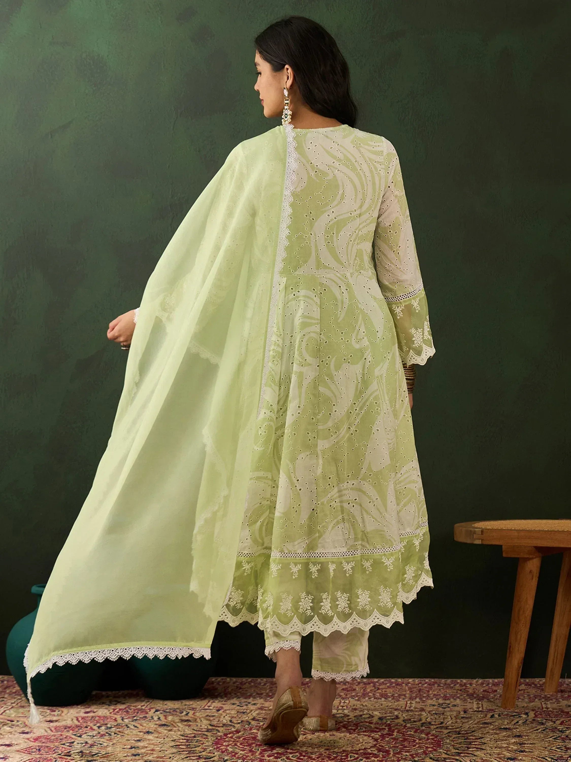 Woman in light green embroidered ethnic kurta set with dupatta, back view