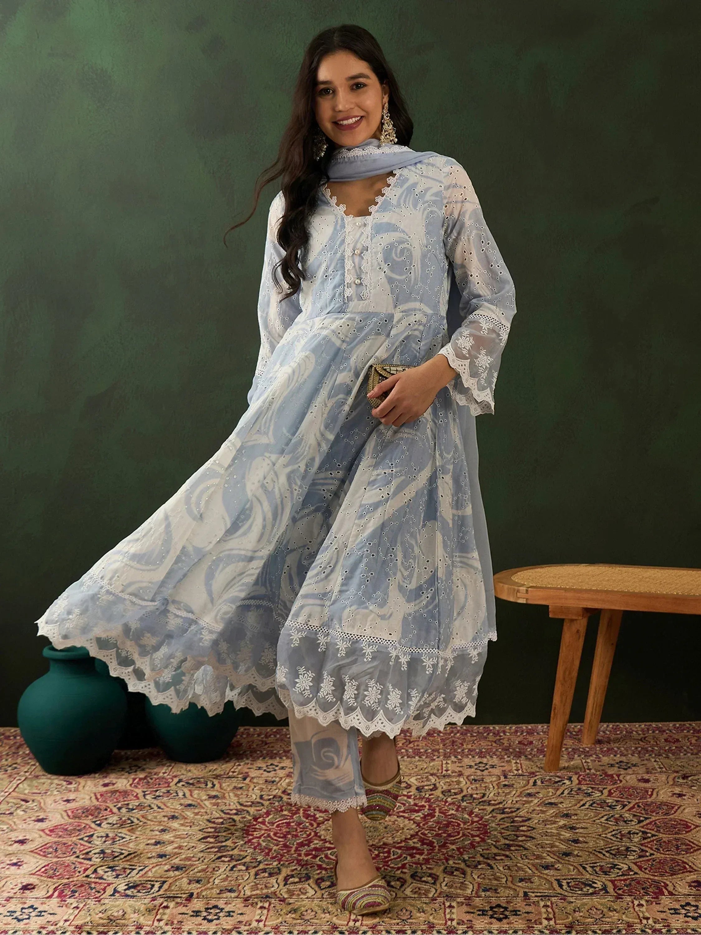 Light blue printed salwar kameez with white lace detailing, perfect for ethnic wear occasions.