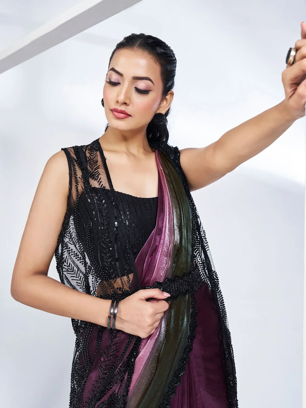 Woman in black sequin ethnic gown with purple ombre dupatta, stylish Indian wear for events