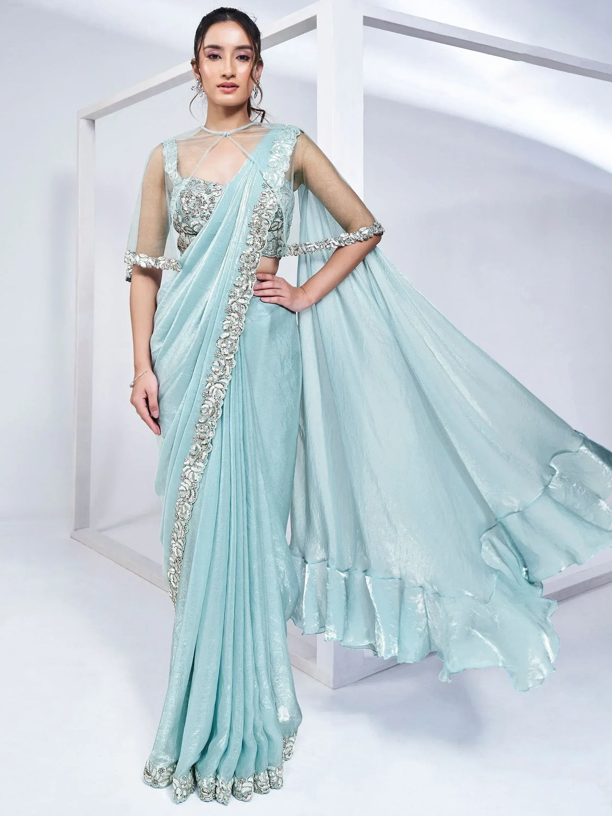 Mint green designer lehenga choli with heavy embroidery and sheer cape, perfect for weddings and parties