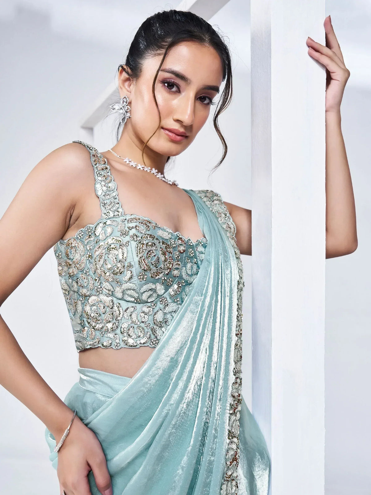 Mint green designer saree with sequin-embellished blouse, perfect for Indian ethnic occasions.
