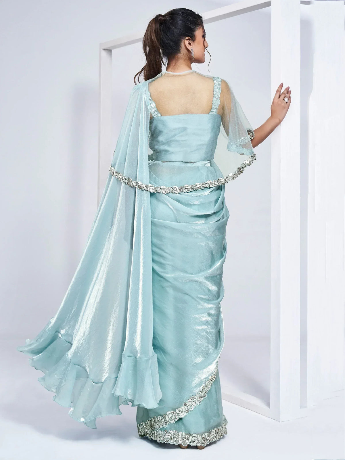 Elegant light blue saree with embellished border and sheer cape, perfect for Indian ethnic wear