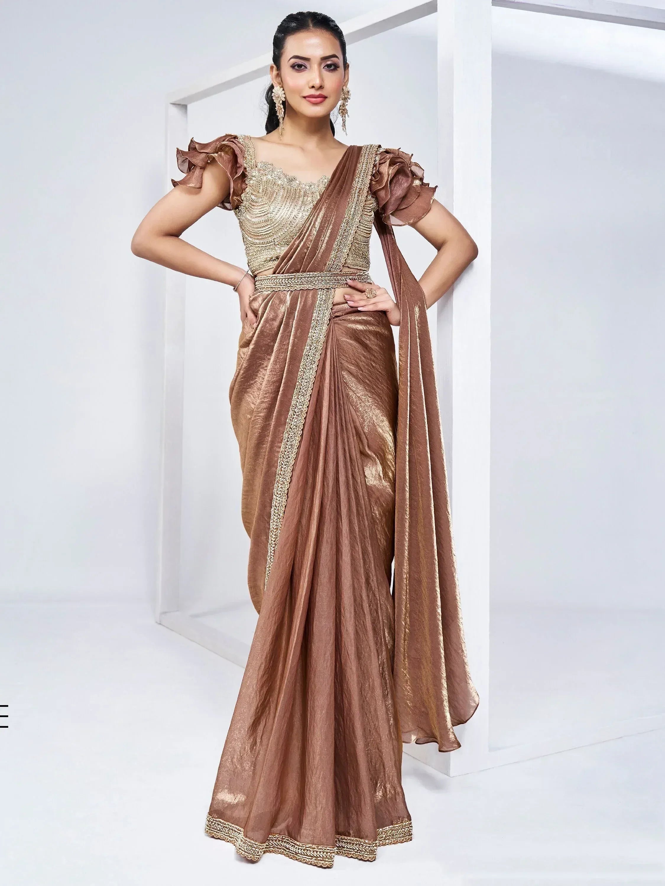 Elegant brown saree with gold embroidery and ruffled sleeves, perfect for Indian ethnic wear occasions.