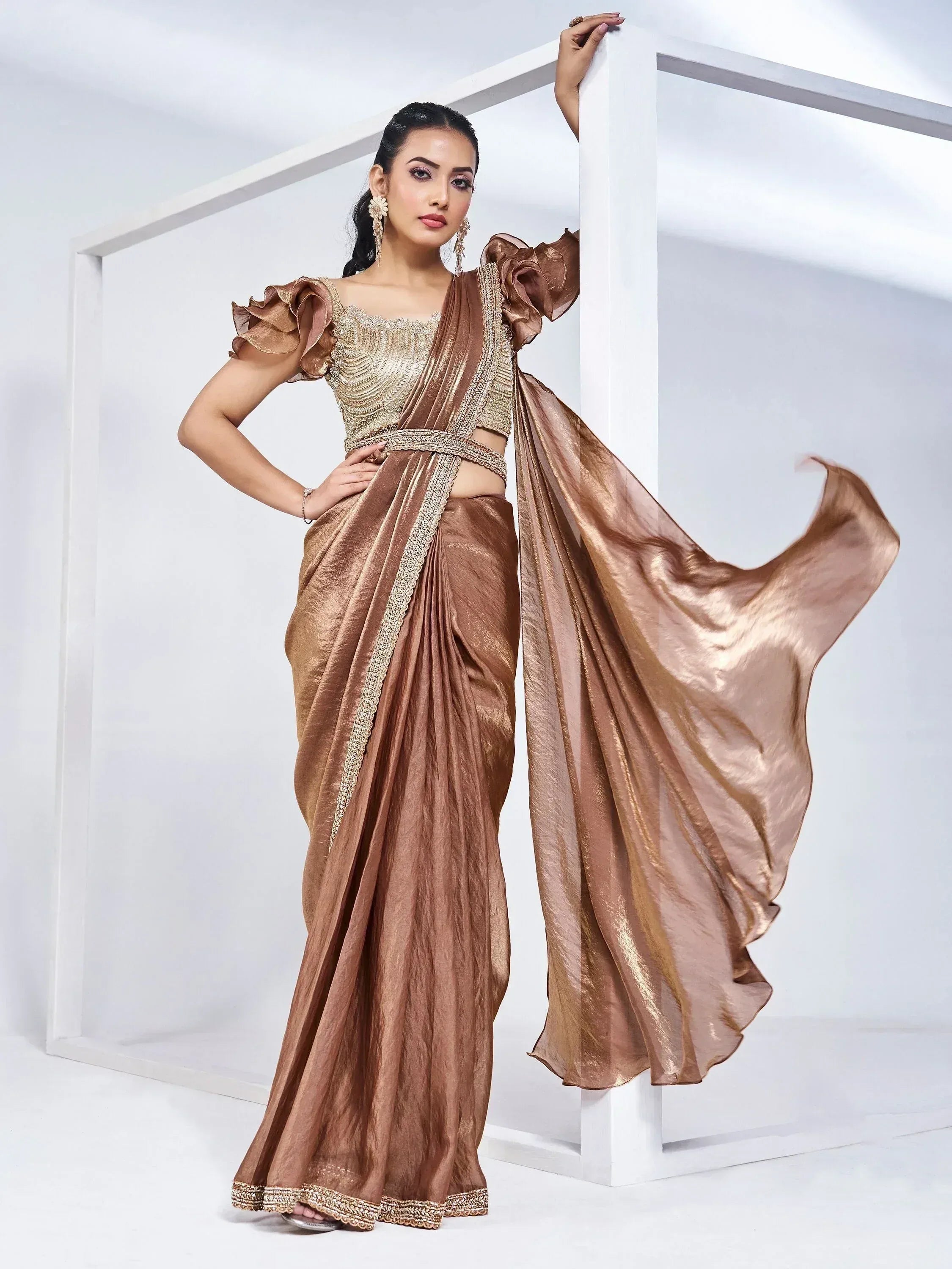 Elegant bronze saree with gold embroidery and ruffled sleeves, perfect for Indian ethnic wear occasions