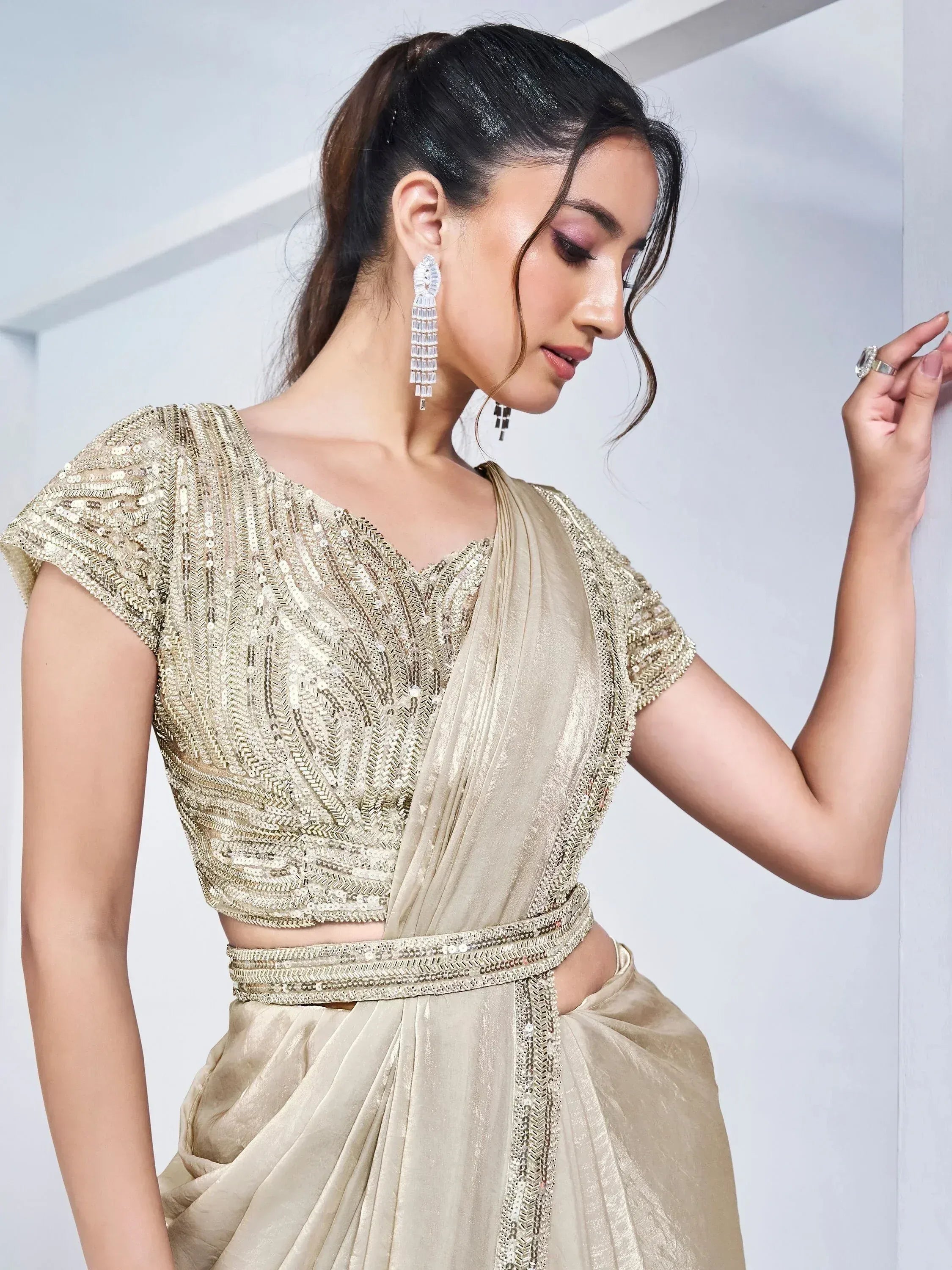 Gold sequin ethnic gown with draped saree-style design, perfect for Indian weddings and festive occasions