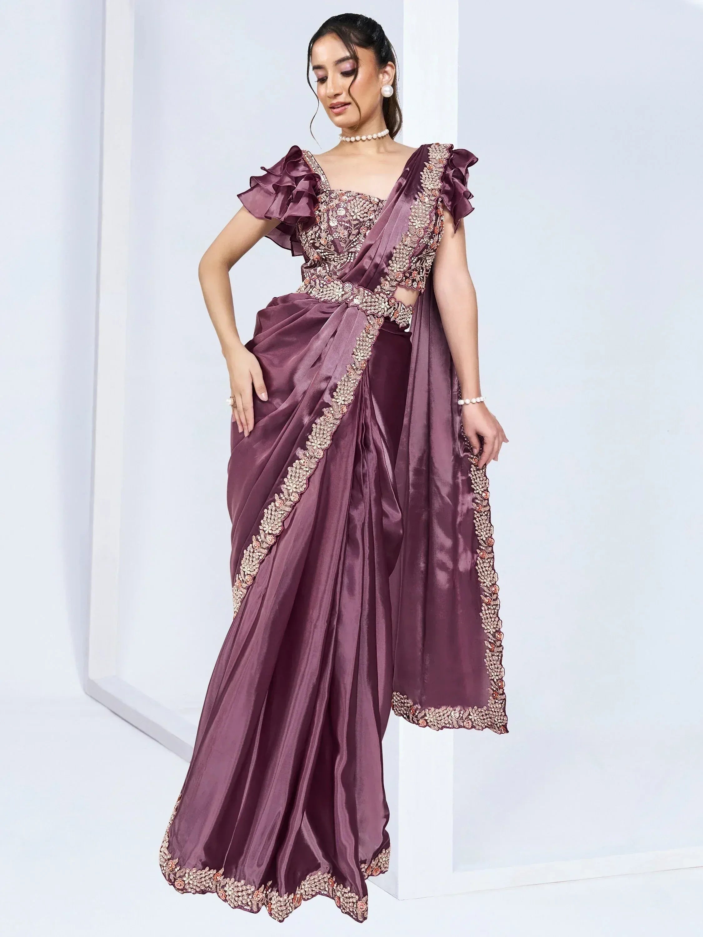 Elegant purple designer saree with floral embroidery and ruffled sleeves, perfect for Indian ethnic occasions.