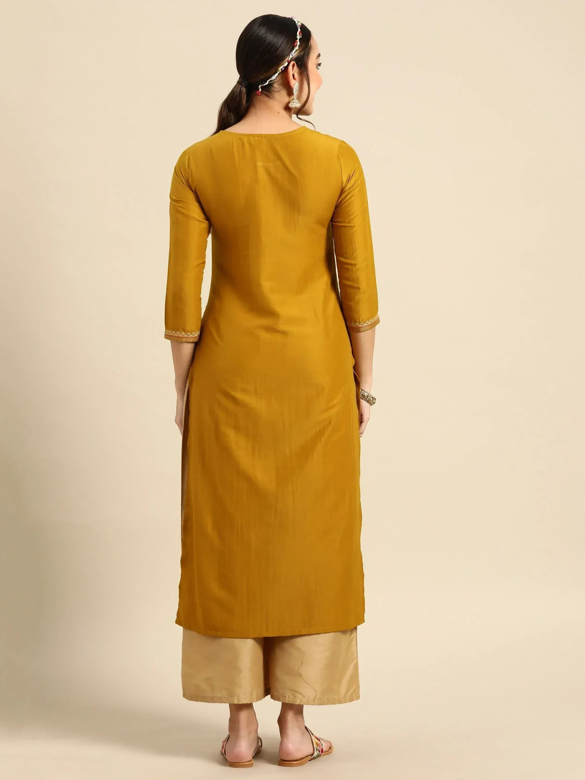 Mustard yellow ethnic kurta with embroidered sleeves paired with palazzo pants, perfect for Indian wear