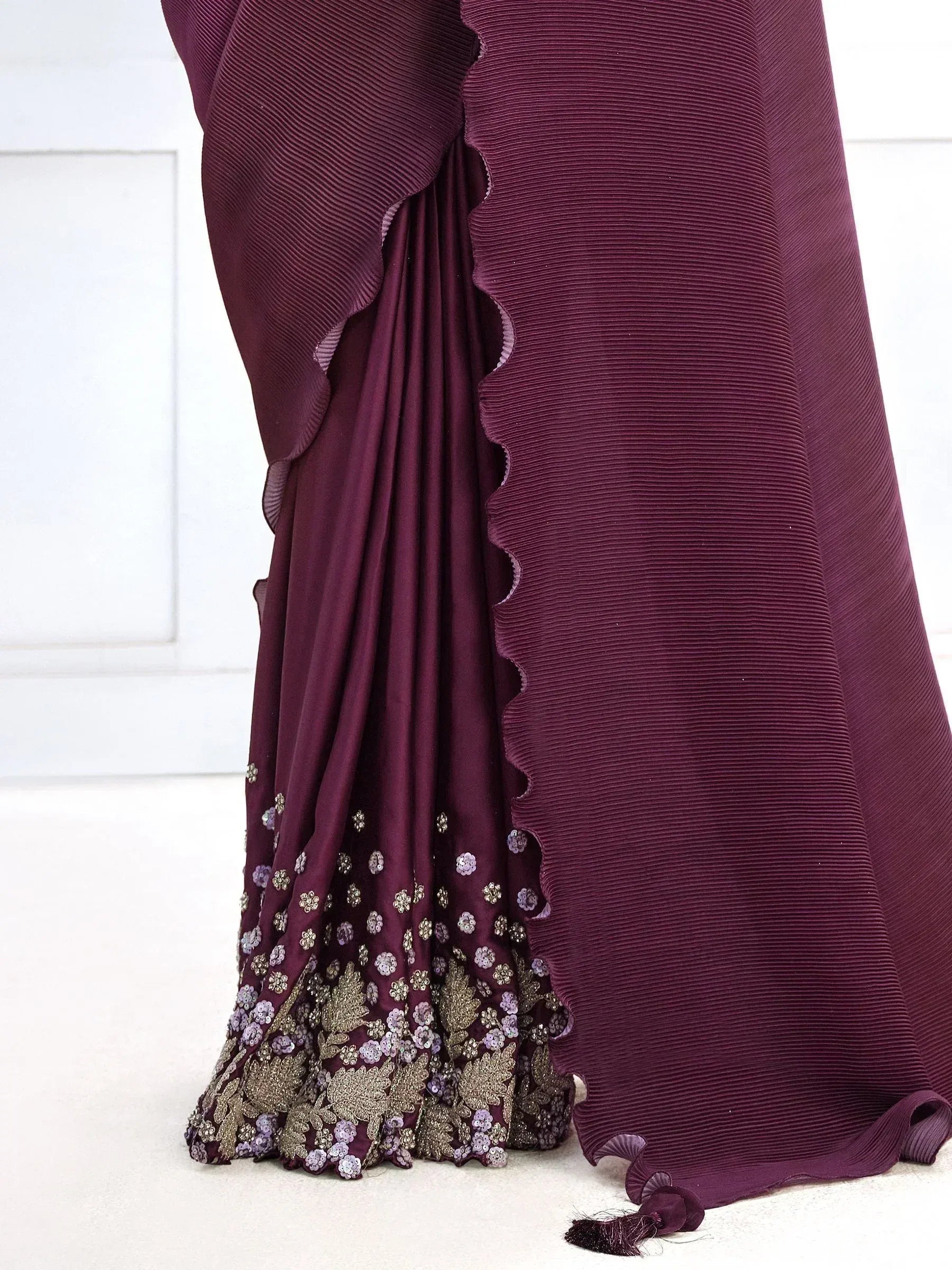 Elegant maroon saree with floral embroidery and pleated border, perfect for Indian ethnic occasions
