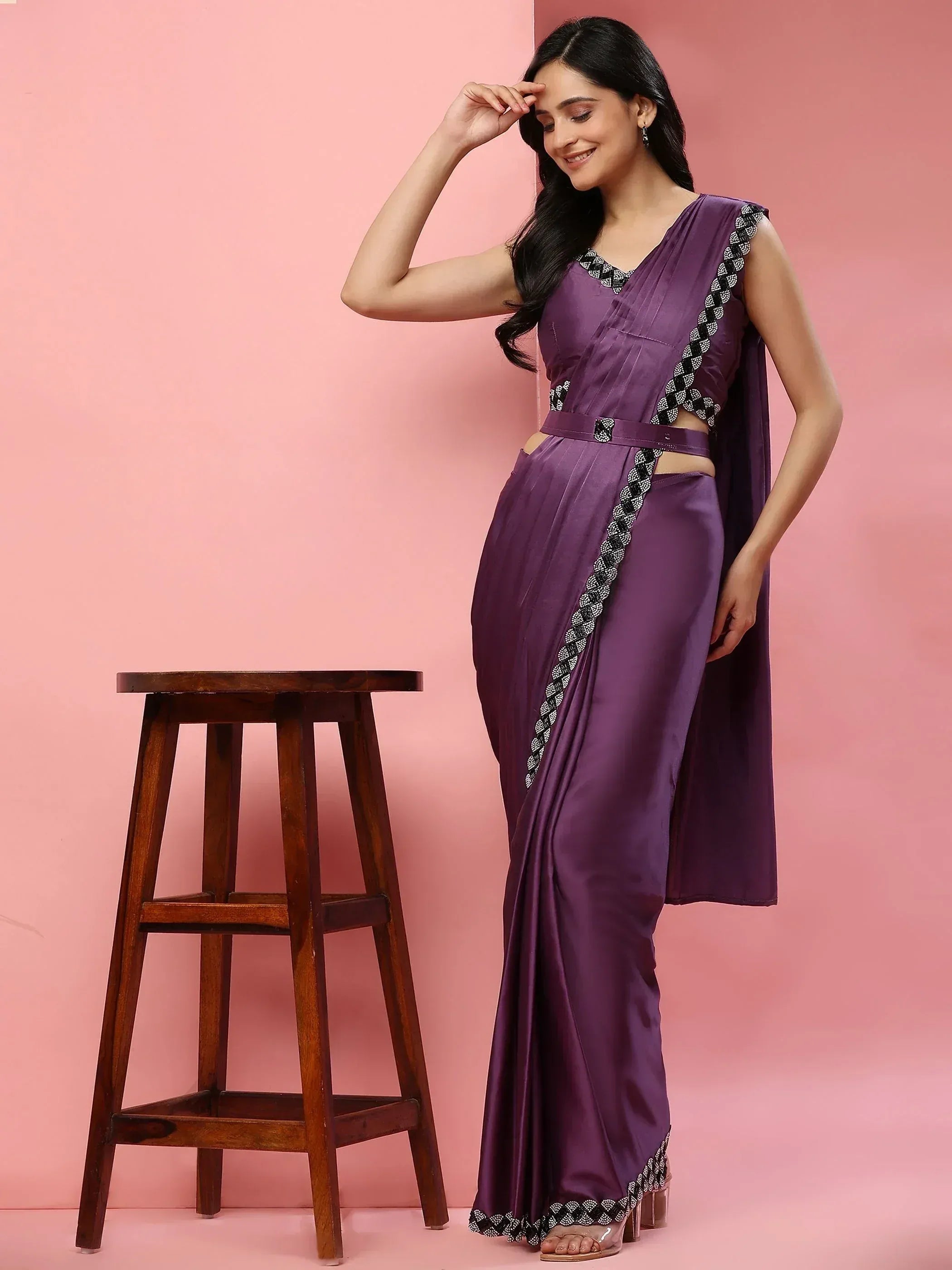 Purple designer saree with black white embroidery, ethnic wear for women, stylish drape against pink backdrop