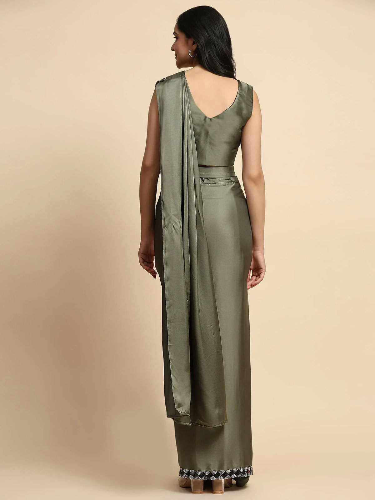 Olive green ethnic gown with draped back and embellished hem, perfect for Indian occasions.