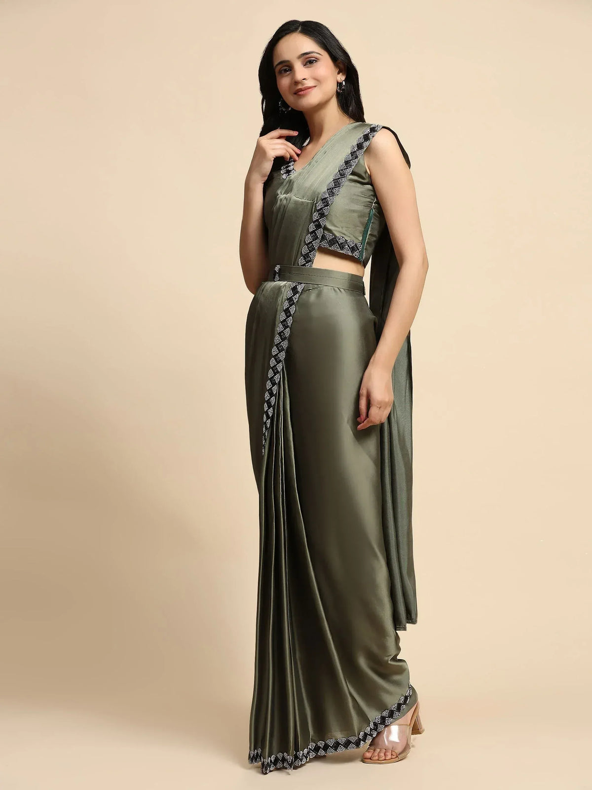 Olive green satin saree with black and white embroidered border, paired with matching crop top for ethnic wear