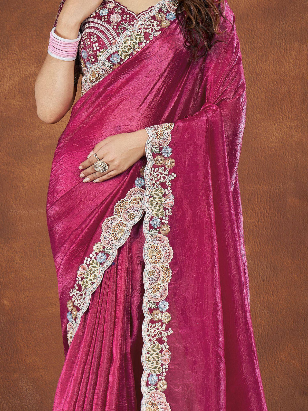 Fuchsia saree with floral embroidery and embellished border, perfect for ethnic occasions