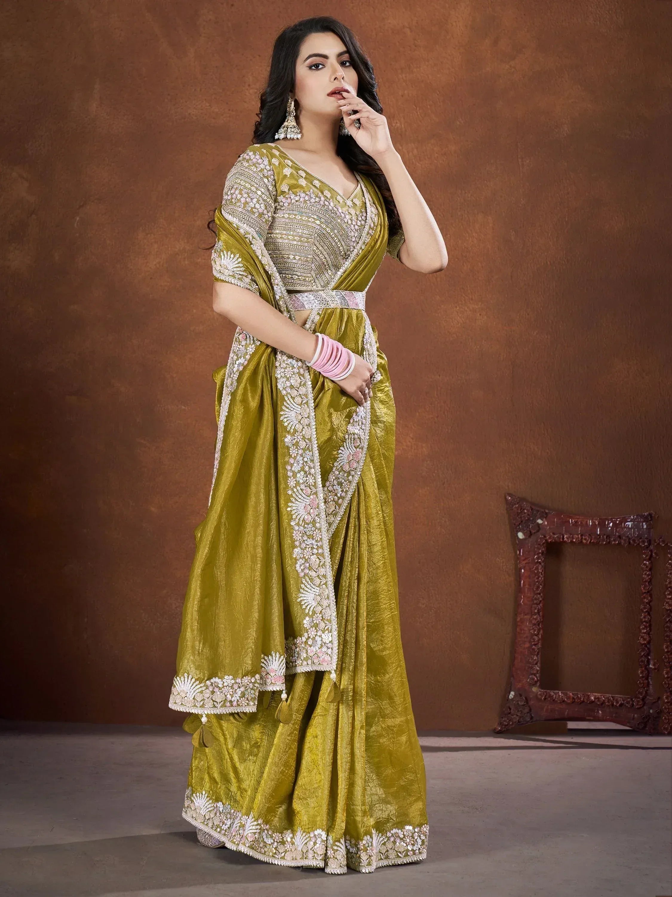 Olive green designer saree with heavy embroidery and sequin work, perfect for Indian ethnic occasions.