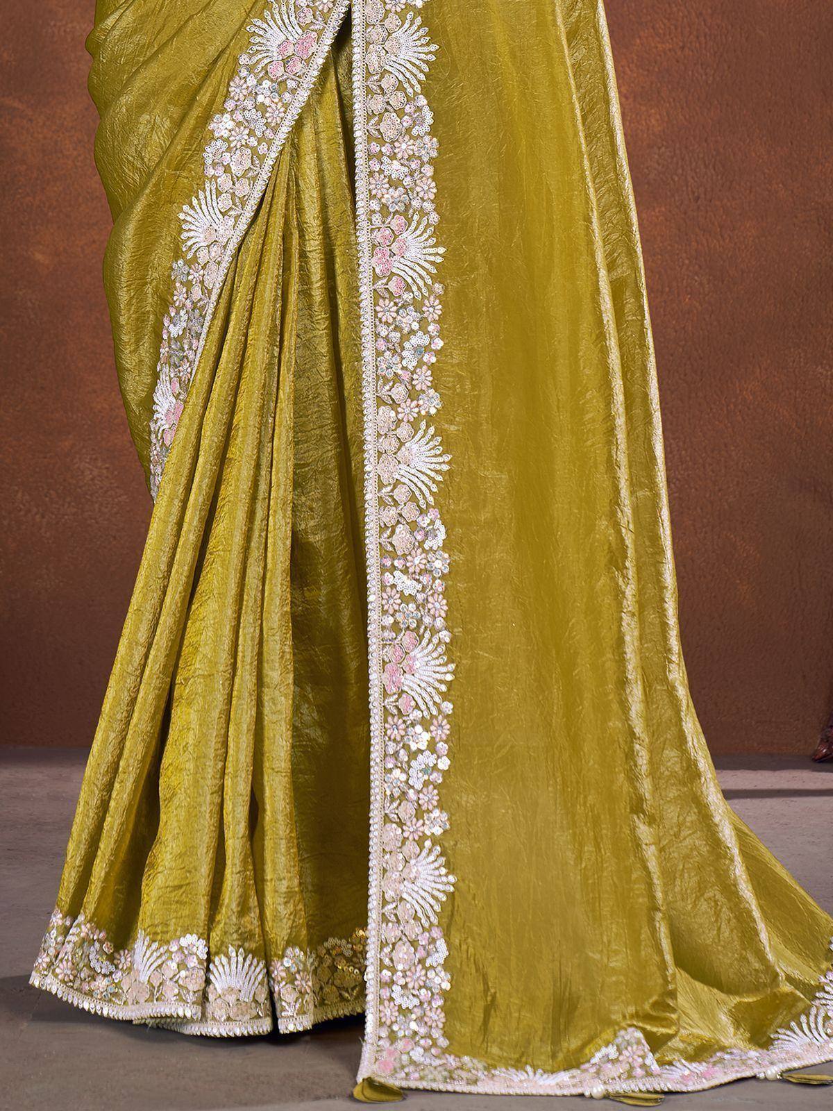 Olive green saree with intricate white and pink floral embroidery, perfect for ethnic occasions