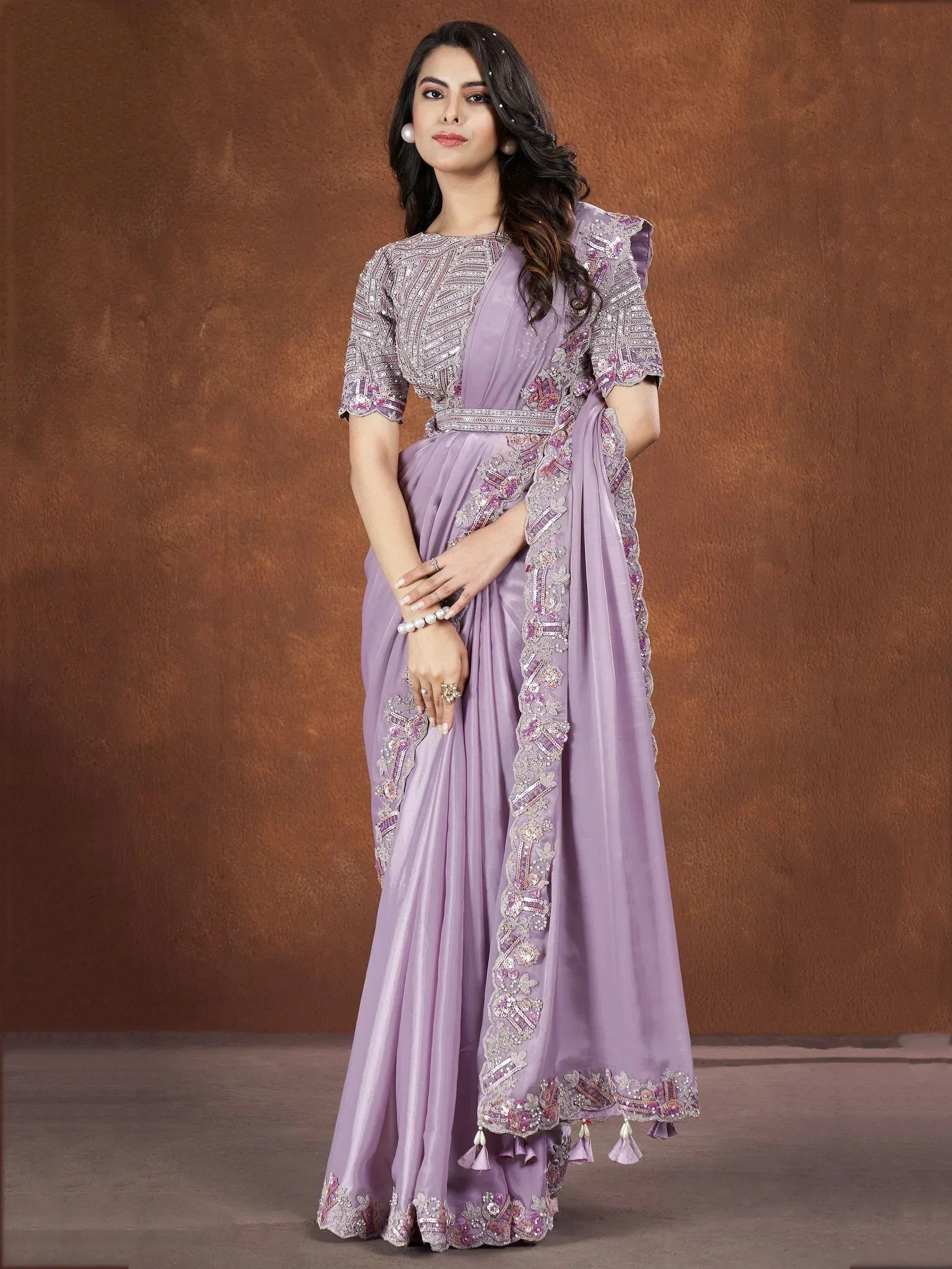 Lavender designer saree with heavy embroidery and tassels, perfect for Indian ethnic occasions