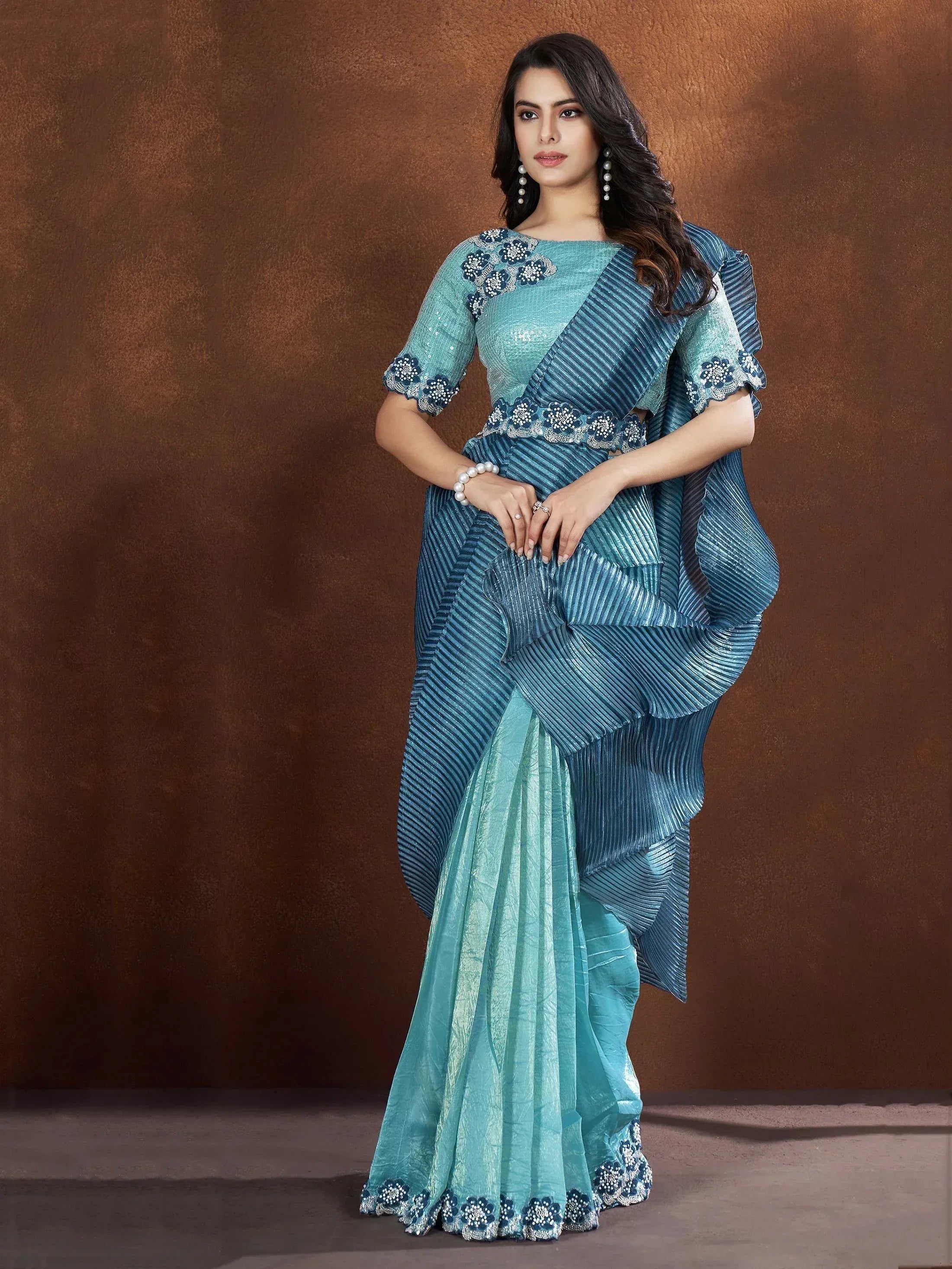 Teal blue designer saree with pleated ruffle pallu and floral embroidery, perfect for ethnic occasions