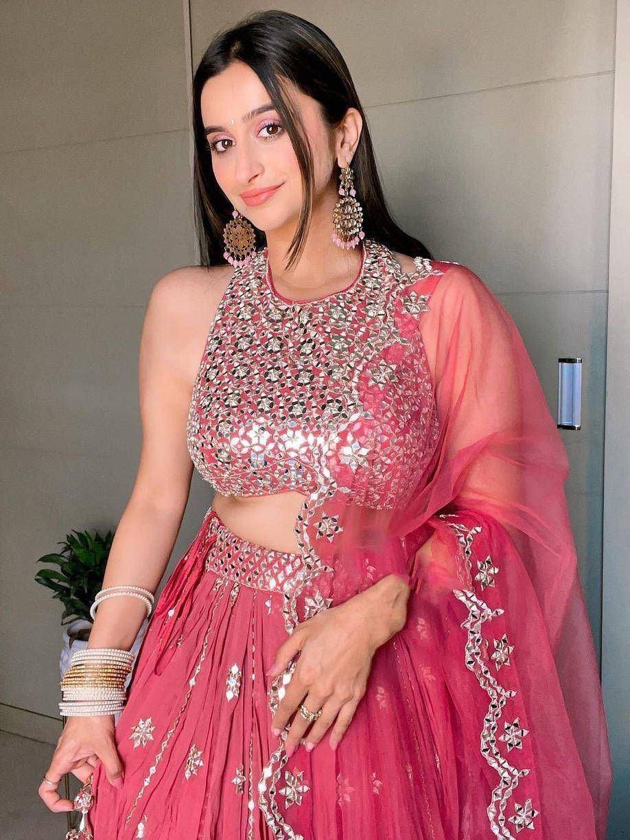 Pink designer lehenga choli with mirror work and sheer dupatta, perfect for Indian ethnic occasions