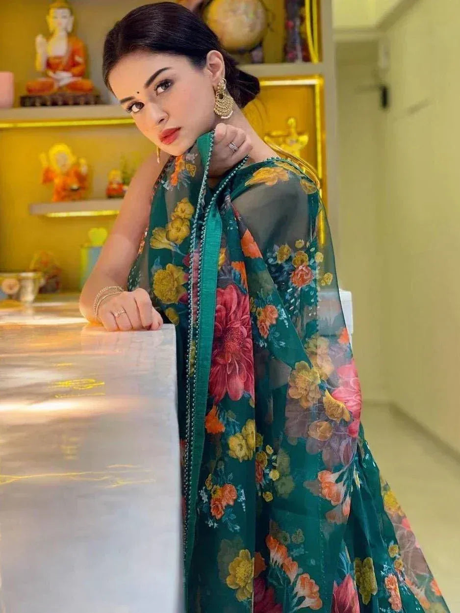 Woman in green floral ethnic gown with sheer sleeves, styled for Indian occasions