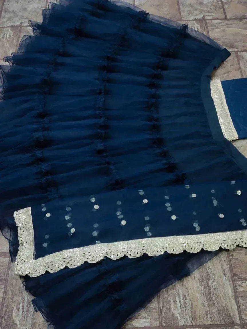 Navy blue ethnic gown with layered tulle, silver sequins, and lace trim for festive occasions