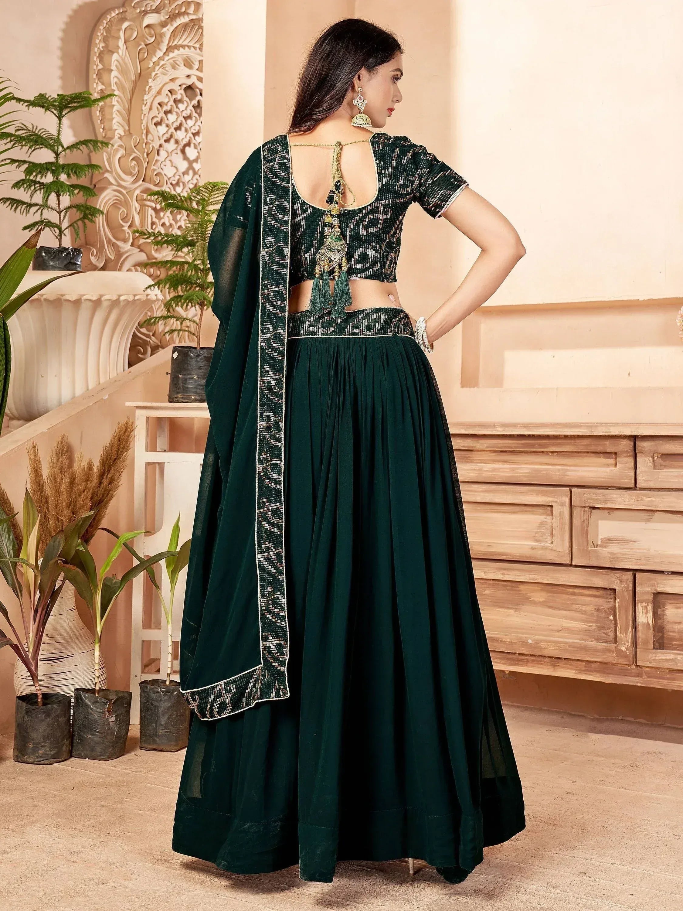 Emerald green designer lehenga choli with sequin work and backless blouse, perfect for Indian ethnic wear occasions