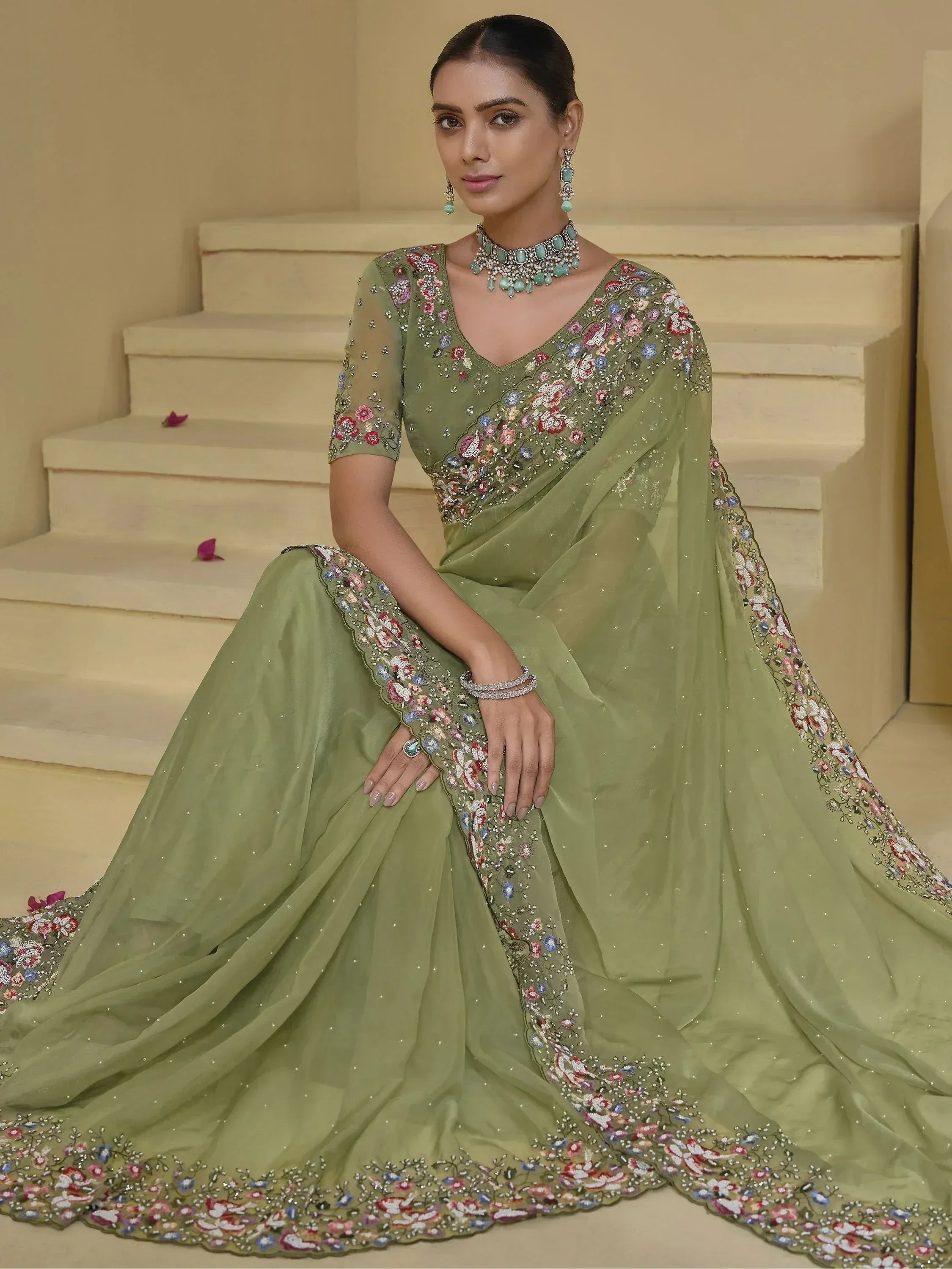 Olive green embroidered saree with floral motifs, perfect for Indian ethnic occasions and weddings.