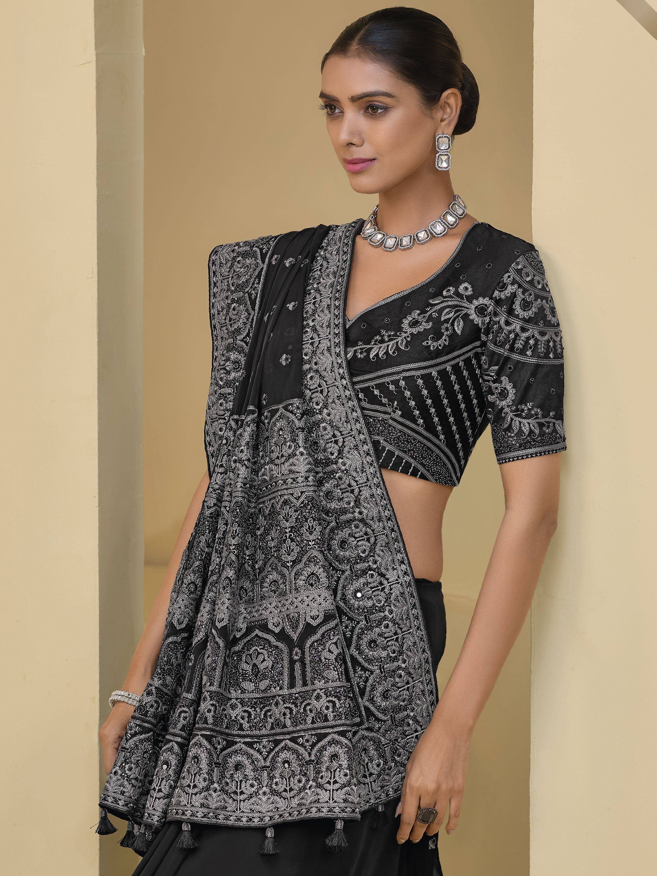 Black embroidered lehenga choli with silver detailing and tassels, perfect for Indian ethnic wear