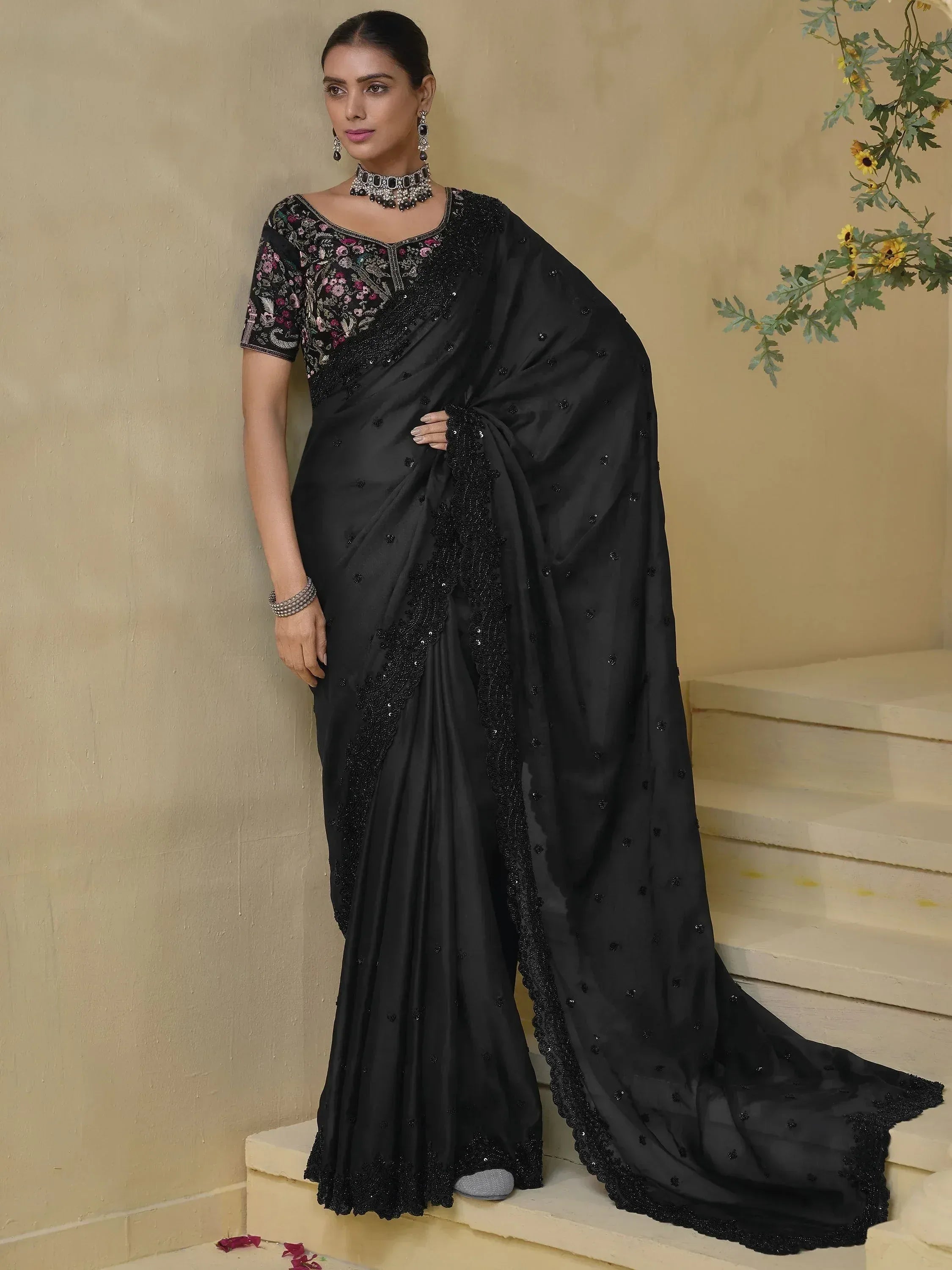 Elegant black saree with floral embroidery and sequin detailing, perfect for Indian ethnic wear occasions.