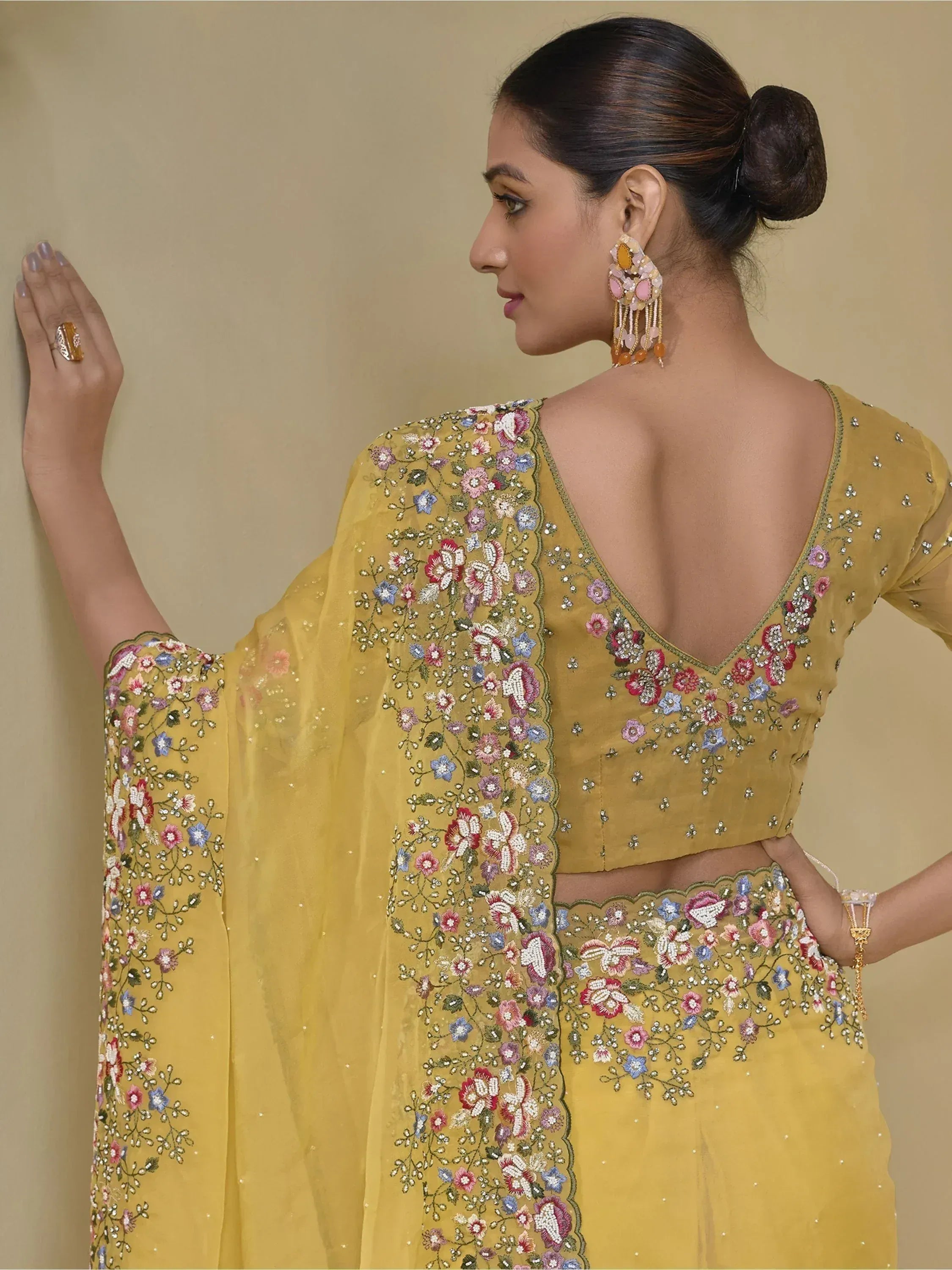 Yellow floral embroidered lehenga choli with backless blouse, perfect for Indian ethnic occasions