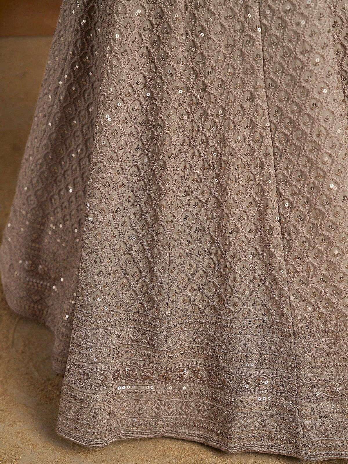 Elegant brown ethnic gown with intricate embroidery and sequin detailing, perfect for Indian festive occasions.