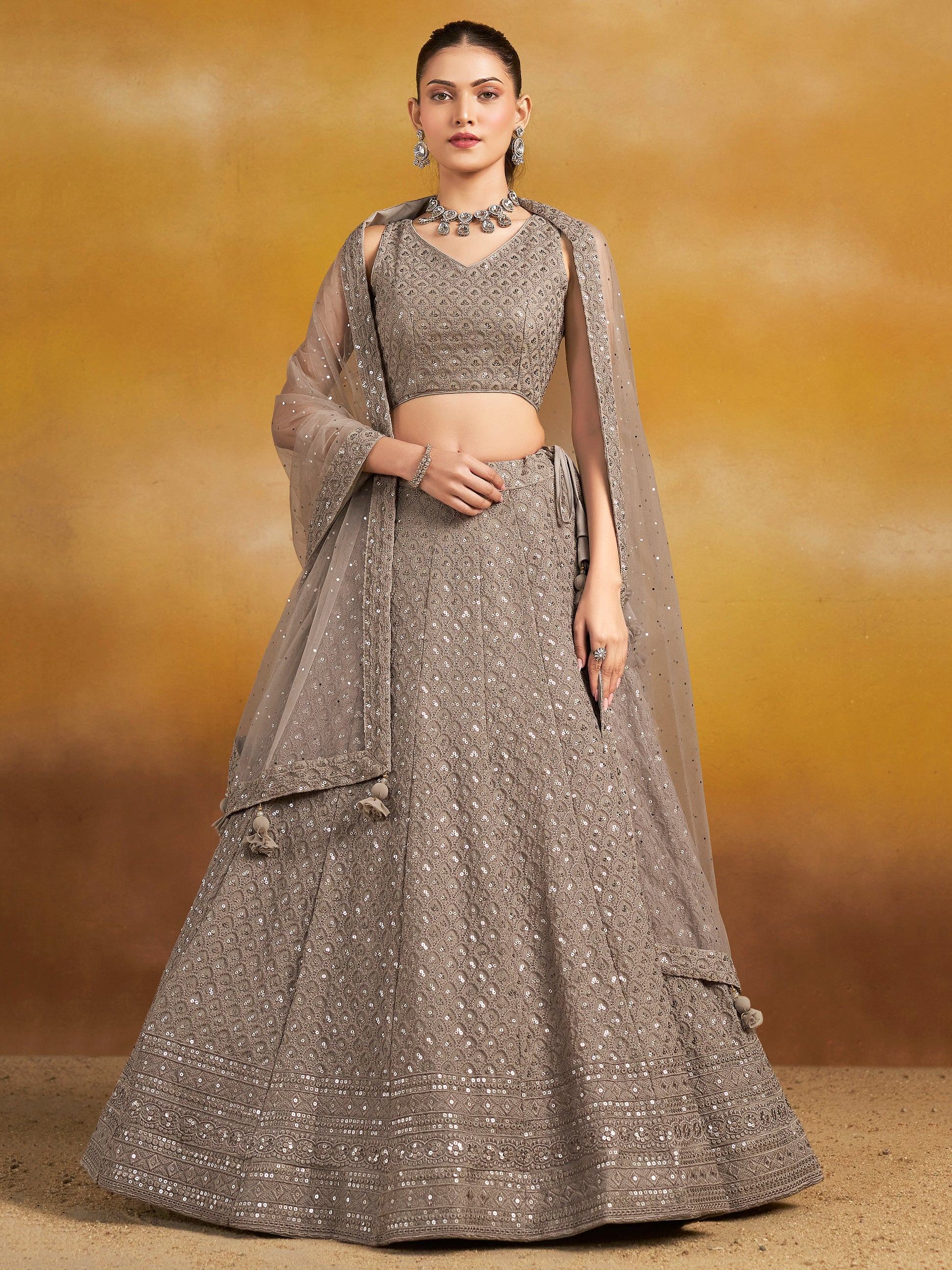 Elegant grey sequined lehenga choli with sheer dupatta, perfect for Indian ethnic occasions and weddings.