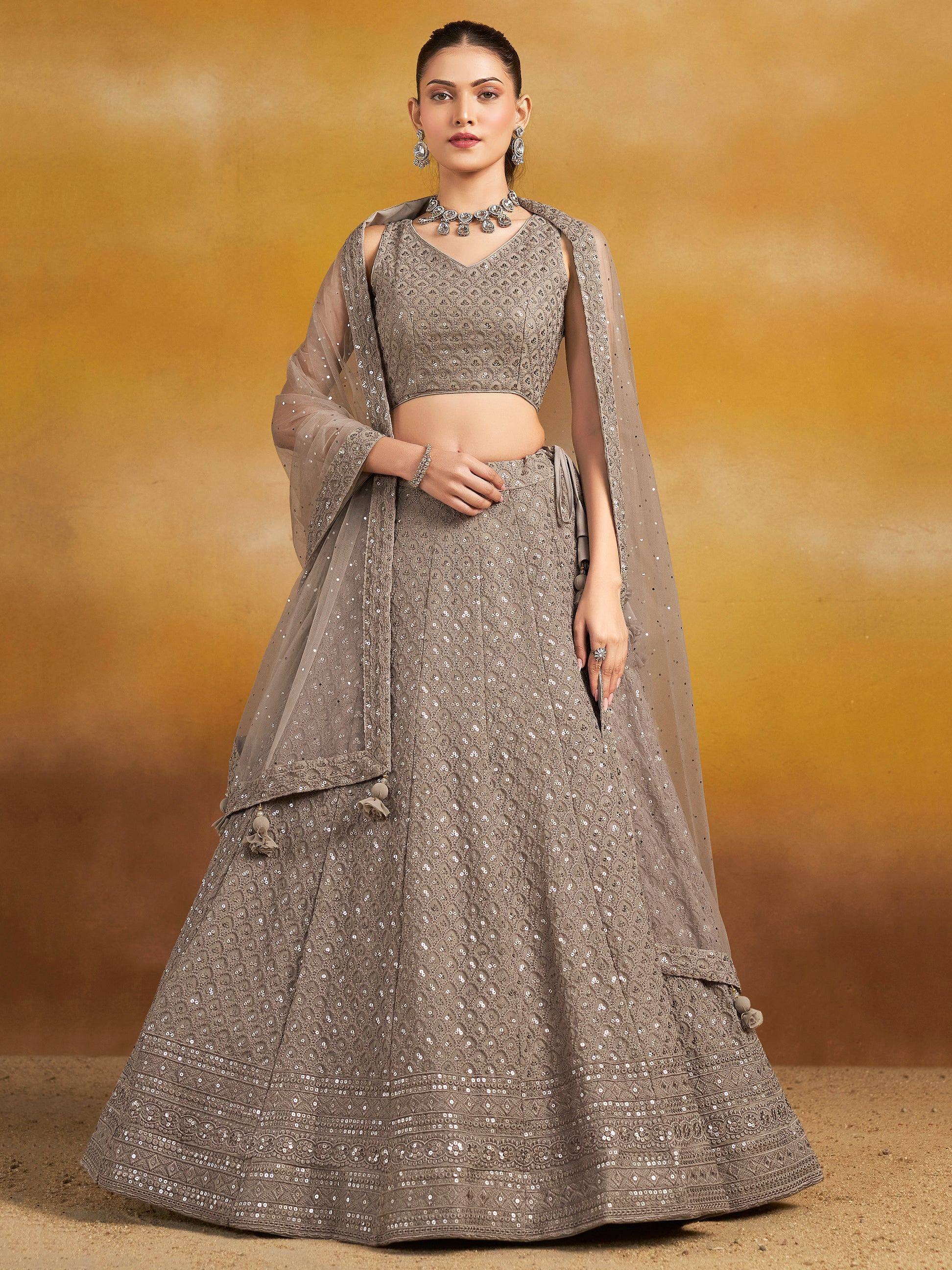 Elegant grey sequined lehenga choli with sheer dupatta, perfect for Indian ethnic occasions and weddings.