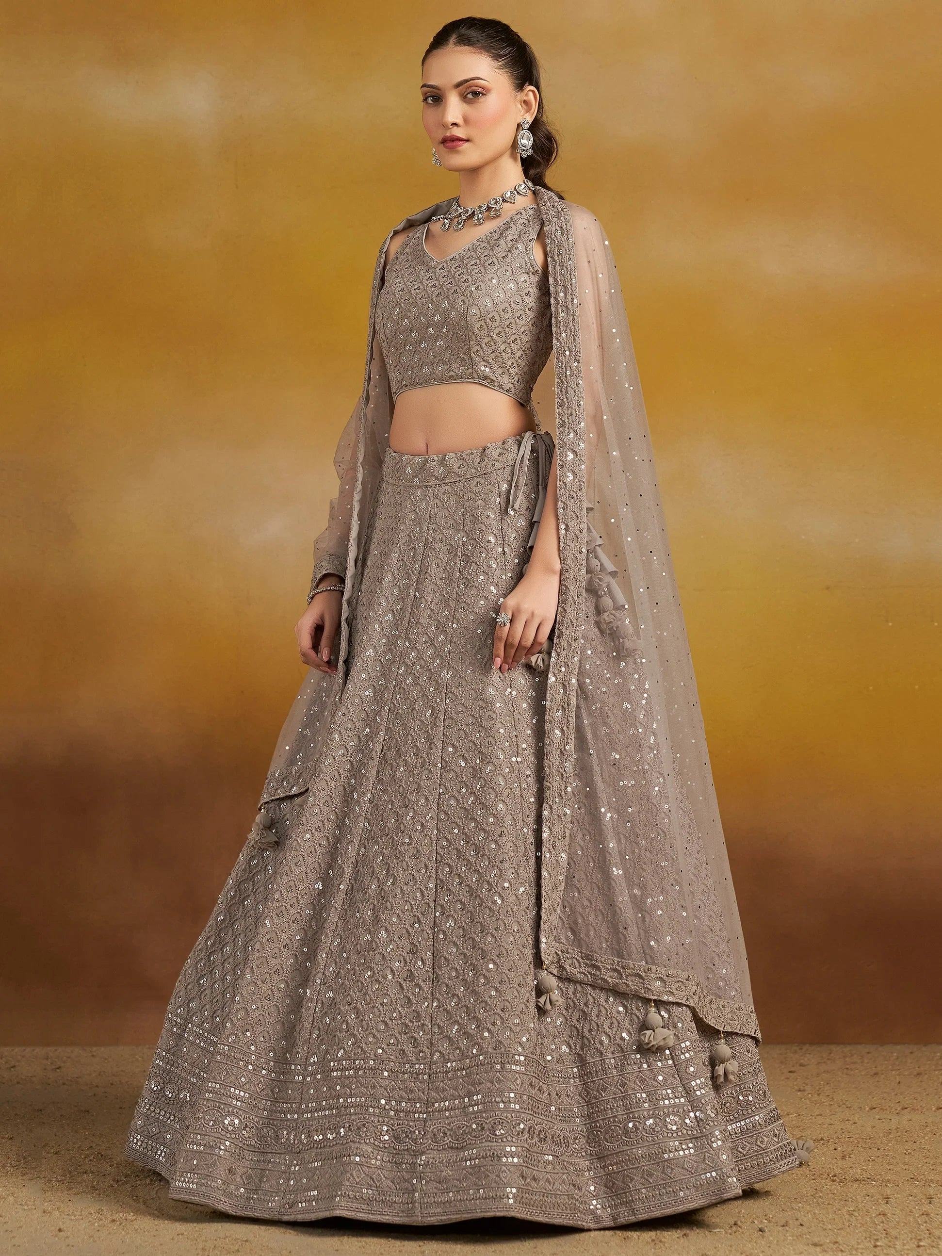 Elegant grey sequin lehenga choli with sheer dupatta, perfect for Indian weddings and festive occasions.