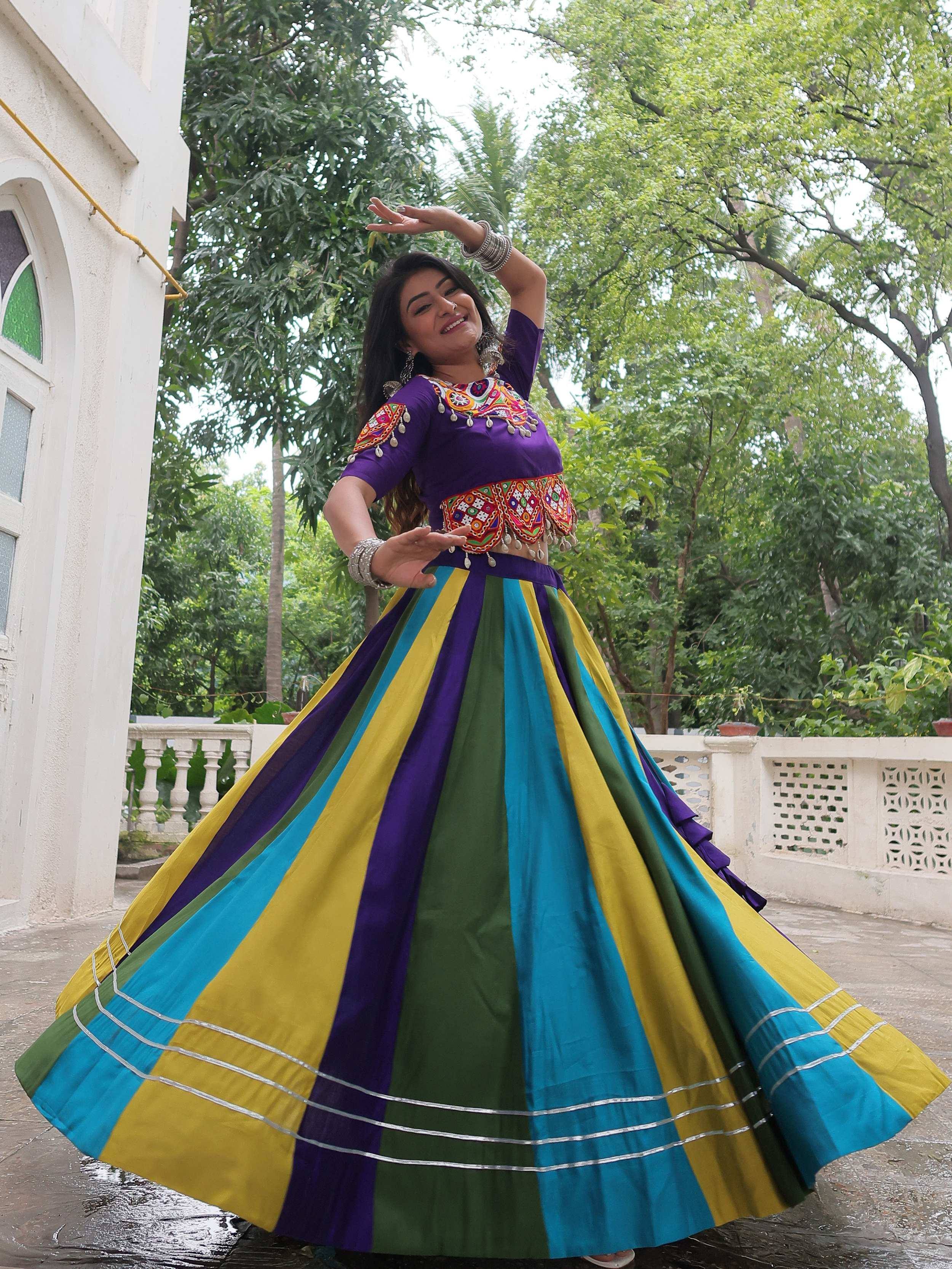 Vibrant multicolor ethnic lehenga choli with embroidered top and striped skirt, perfect for festive occasions.
