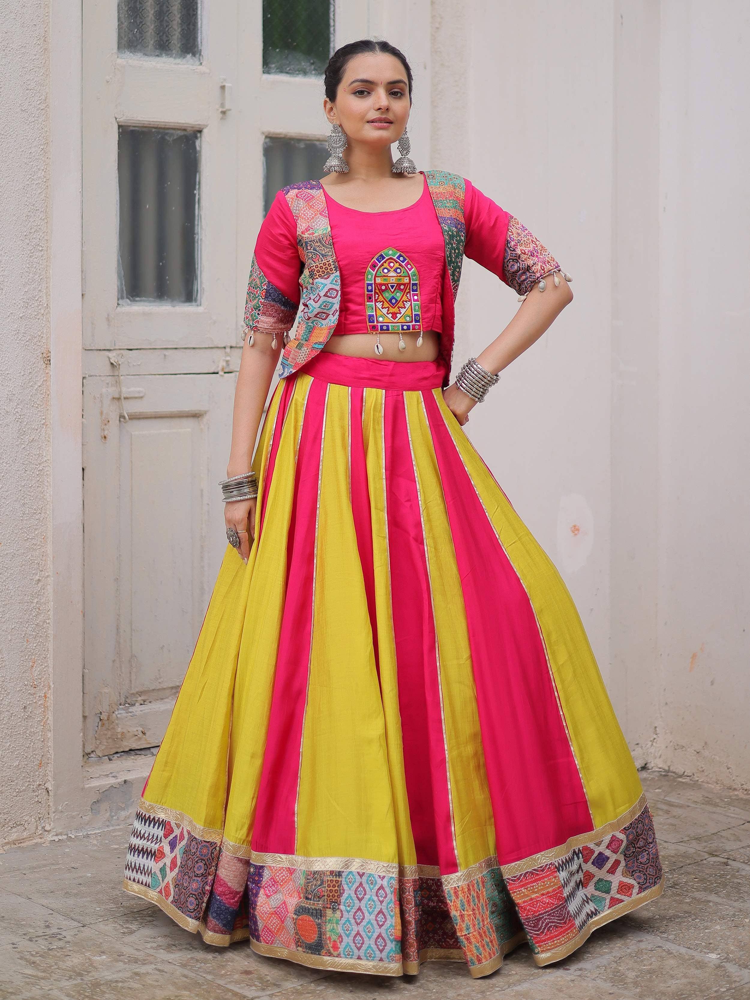 Vibrant pink and yellow lehenga choli with embroidered crop top and patchwork dupatta, perfect for Indian ethnic wear.