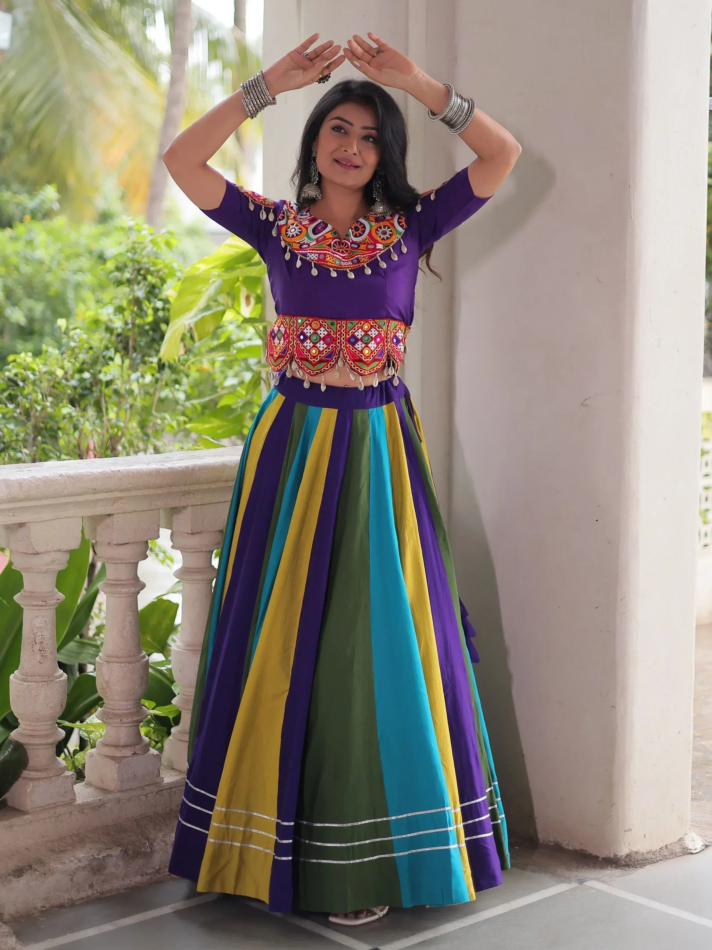 Vibrant purple lehenga choli with colorful embroidery and striped skirt, perfect for festive occasions.